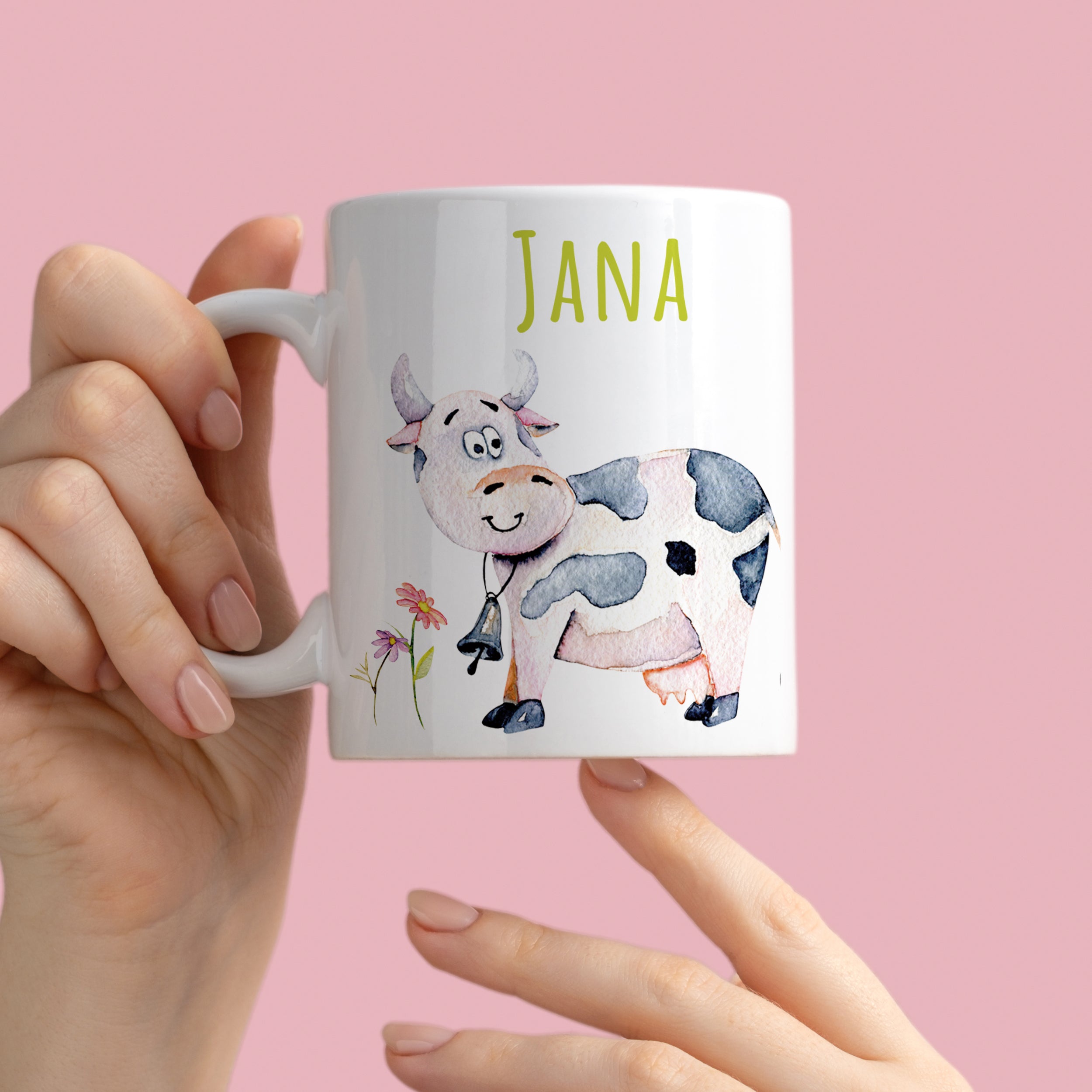 Tasse mit Kuh-Motiv und dem Namen "Jana" in Grün.