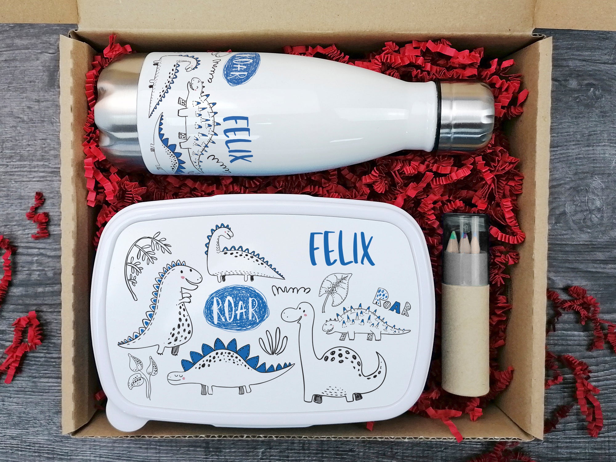 Isolierte Box mit dino-motivierter Trinkflasche und Brotdose.