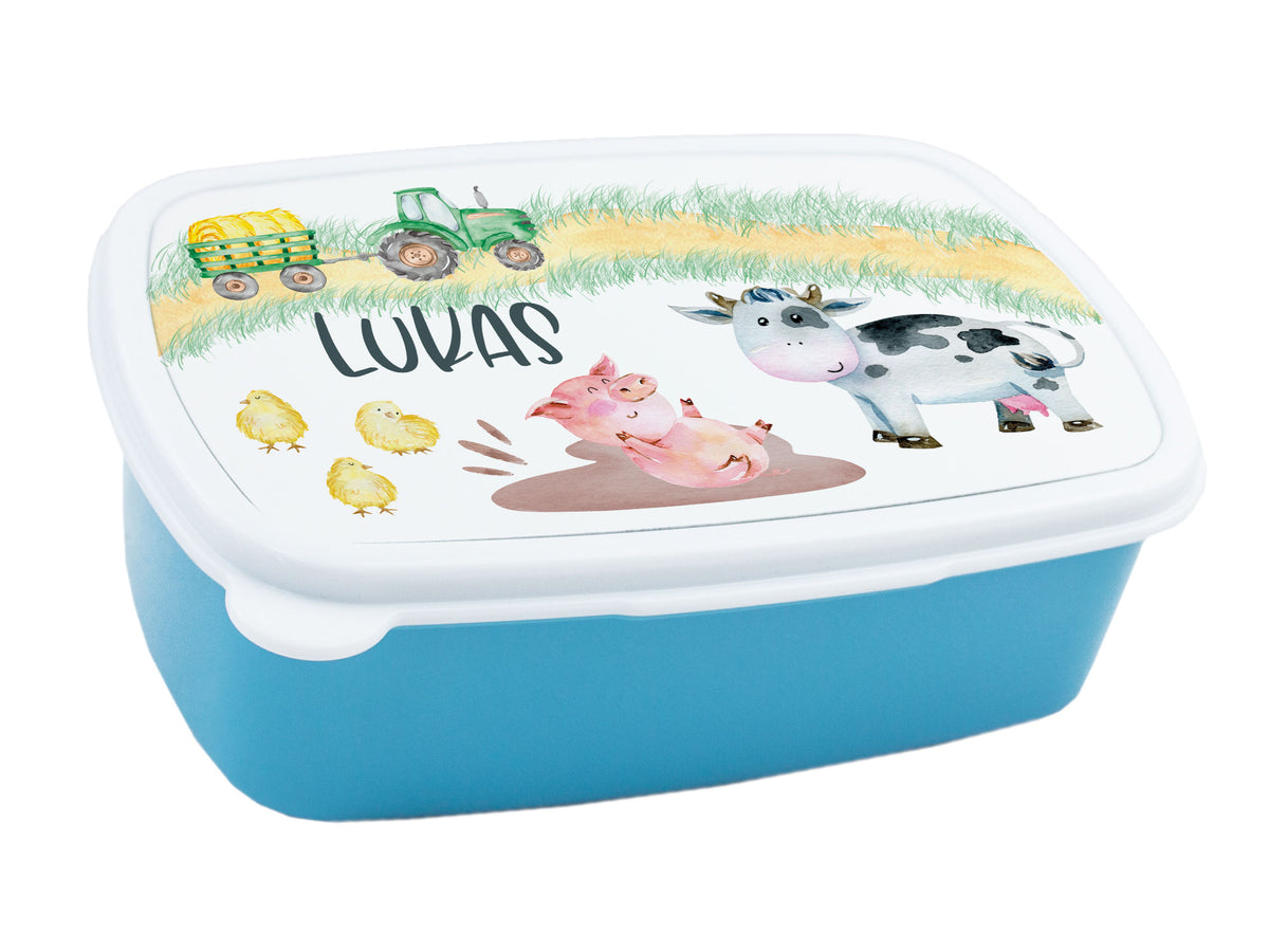Blaue Brotbox mit Tiermotiven und Namen „Lukas“.