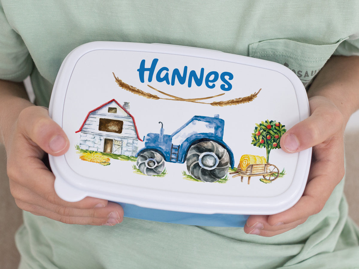 Bunte Brotdose mit Traktor-Design und Namen Hannes.