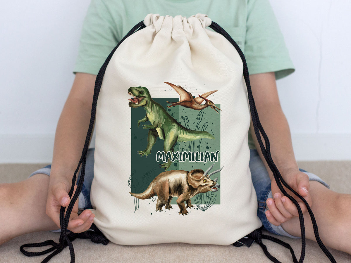 Beige Turnbeutel mit Dinosaurier-Motiv und Namen "MAXIMILIAN".