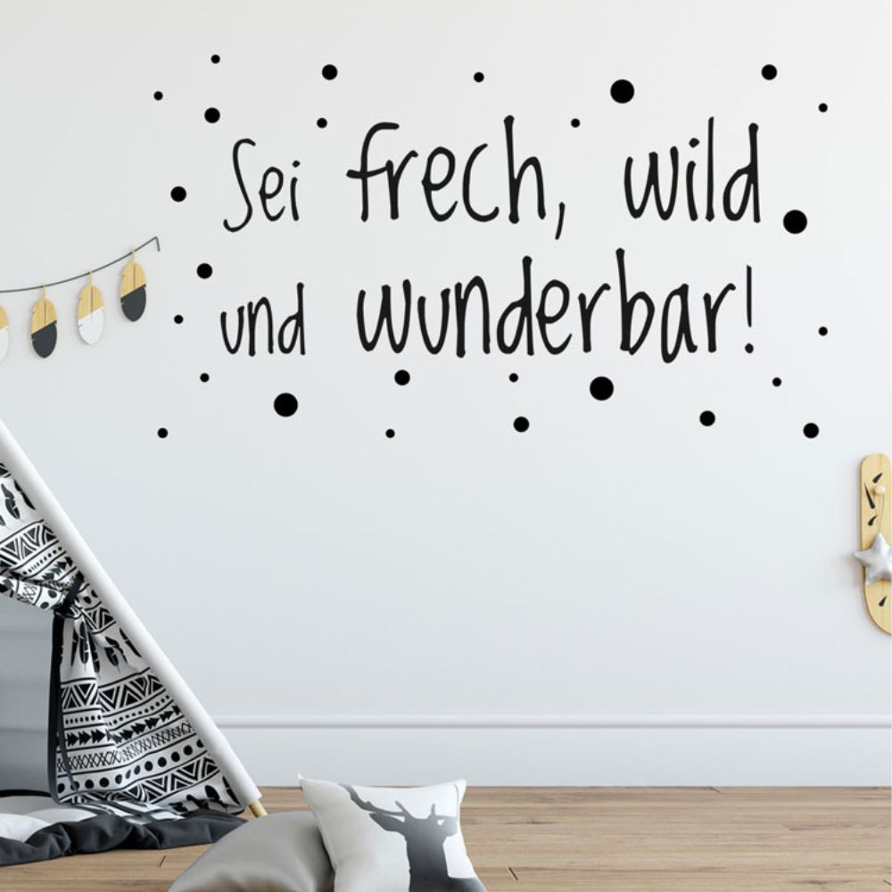 Schwarzer Wandaufkleber mit Spruch und Punkten.