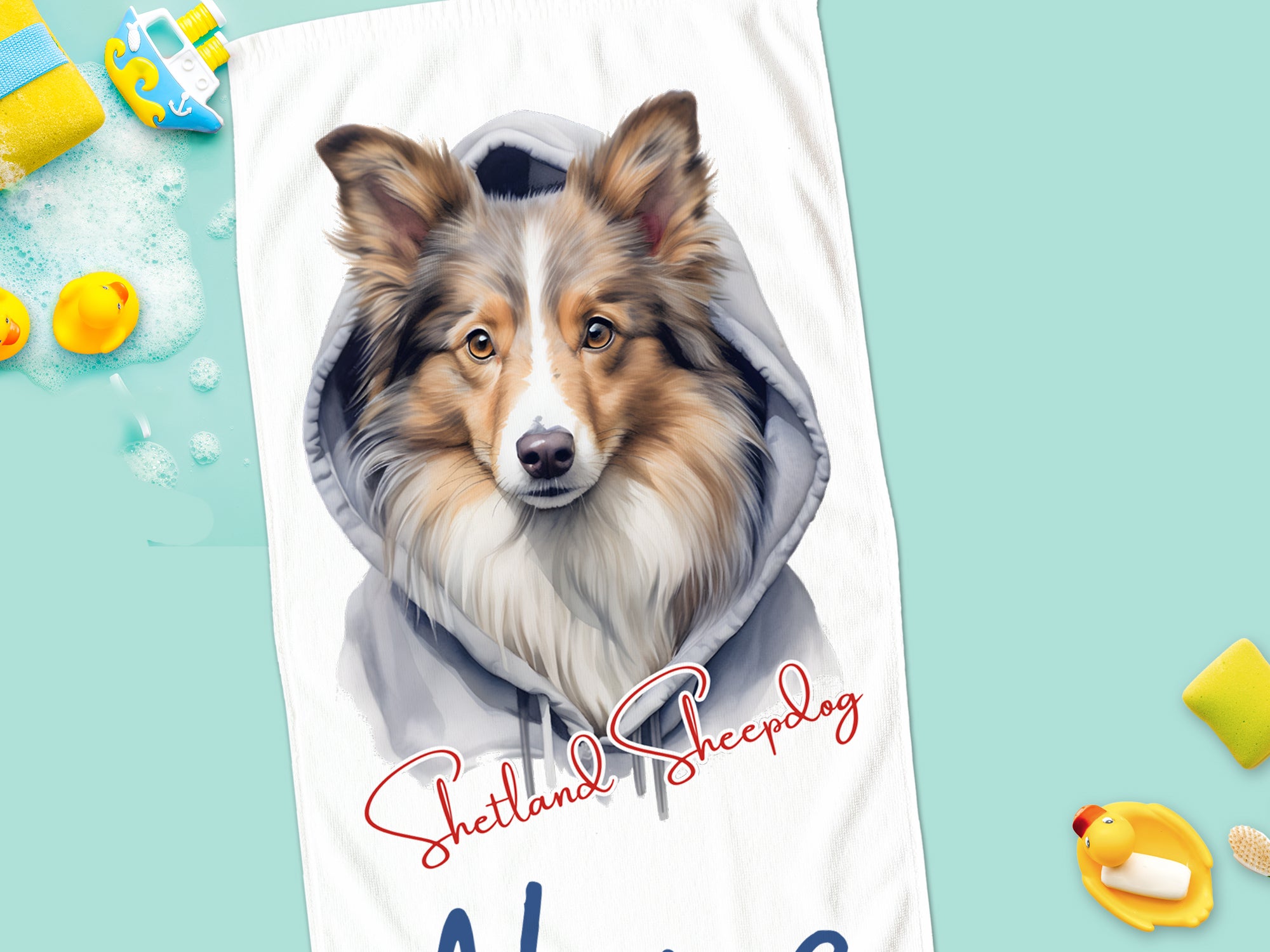Shetland Sheepdog mit Kapuzenpullover auf Handtuch.