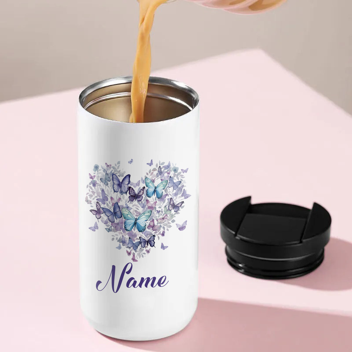 Weißer Becher mit Schmetterlingsherz und personalisiertem Namen.