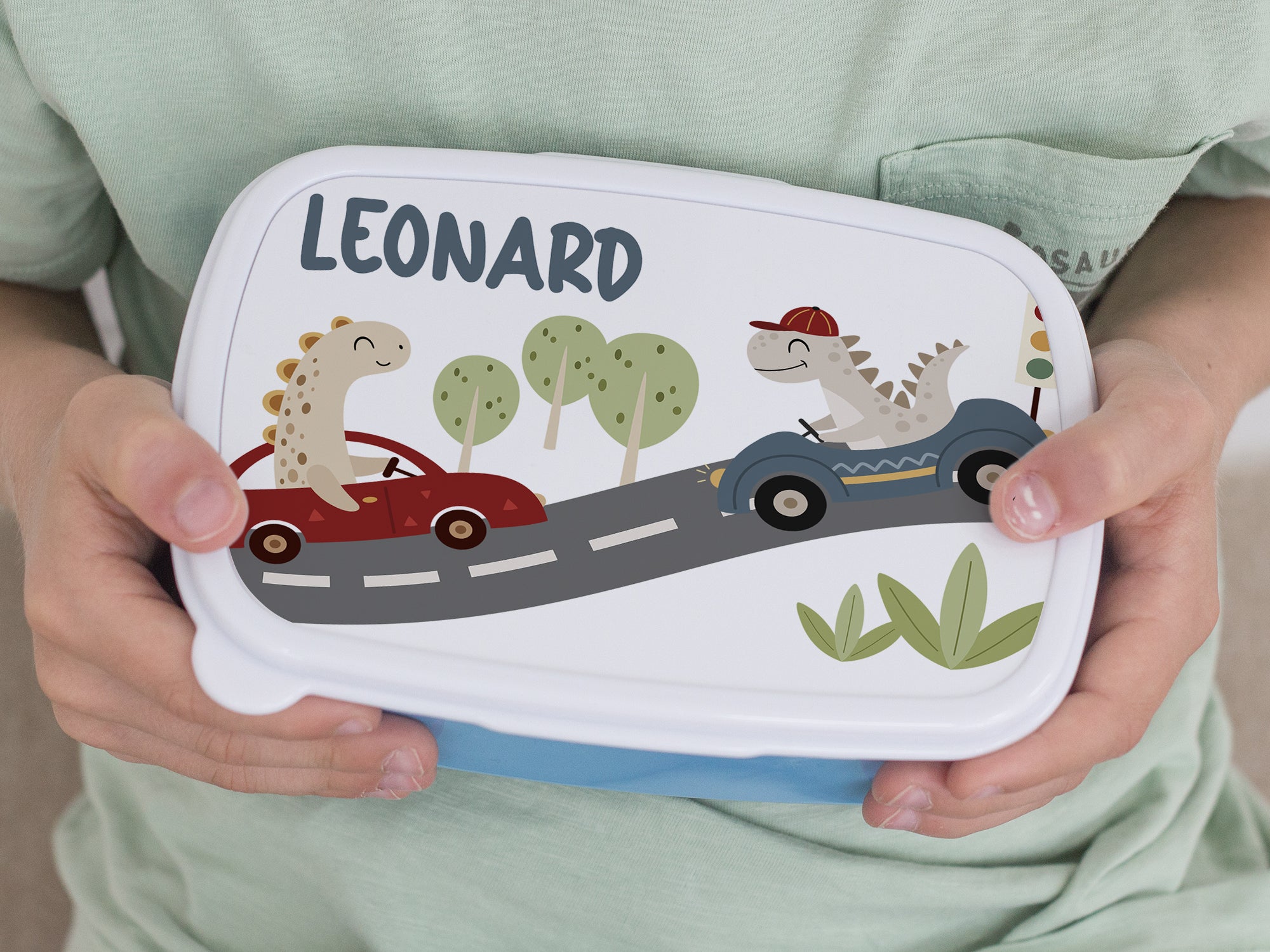 Bunte Brotdose mit Dinosauriern und Namen "Leonard".