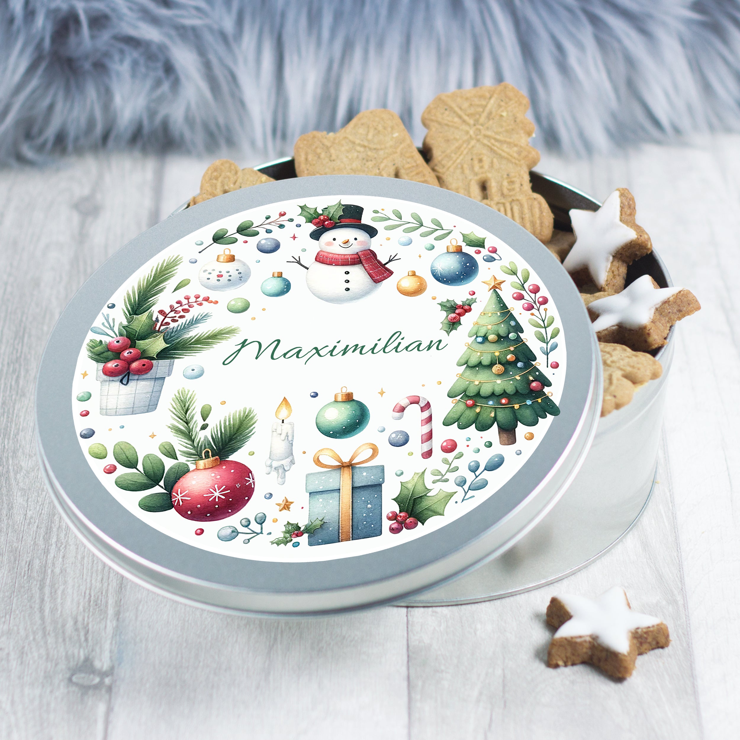 Runde Keksdose mit weihnachtlichem Design und Namen.