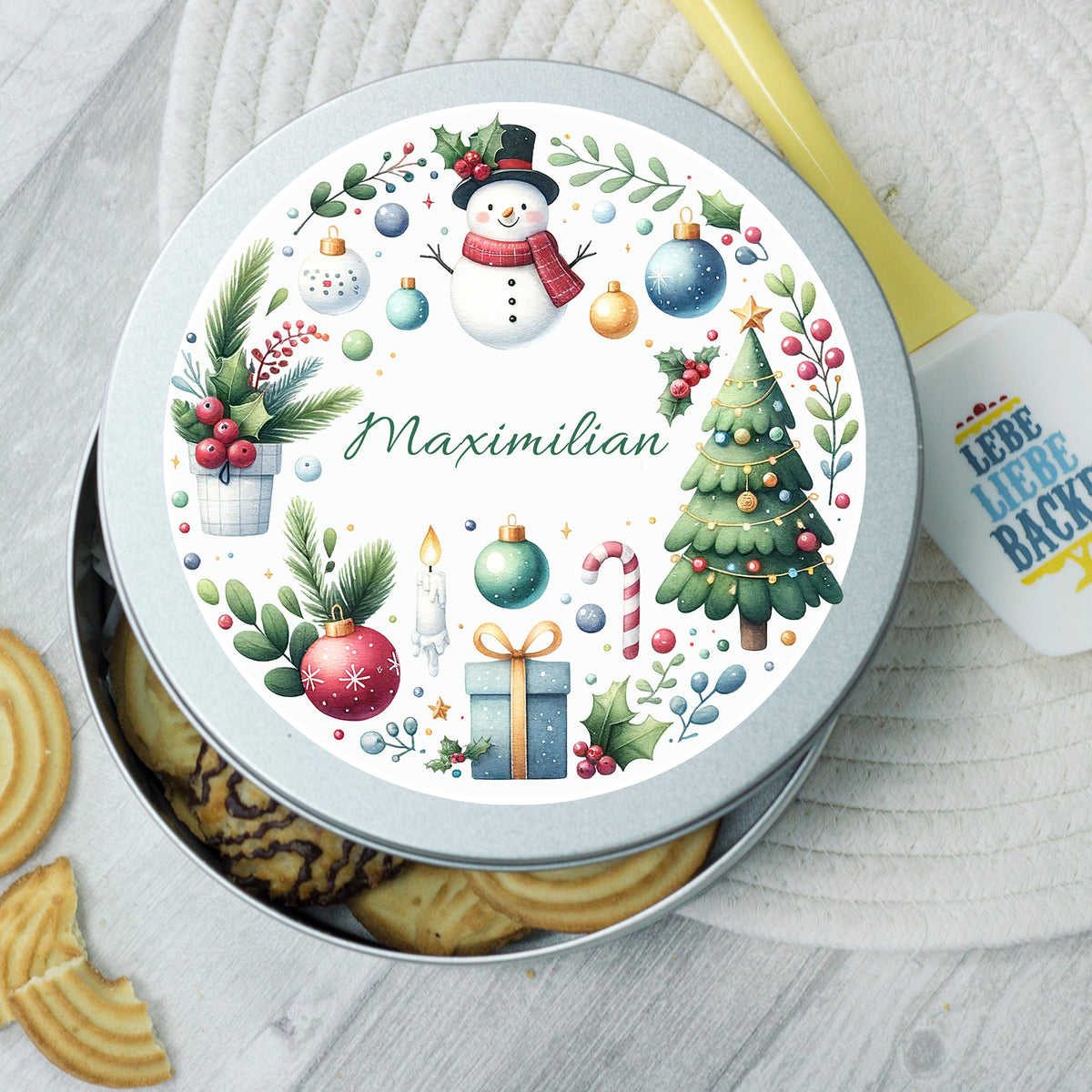 Runde Keksdose mit Weihnachtsmotiven und Namen Maximilian.