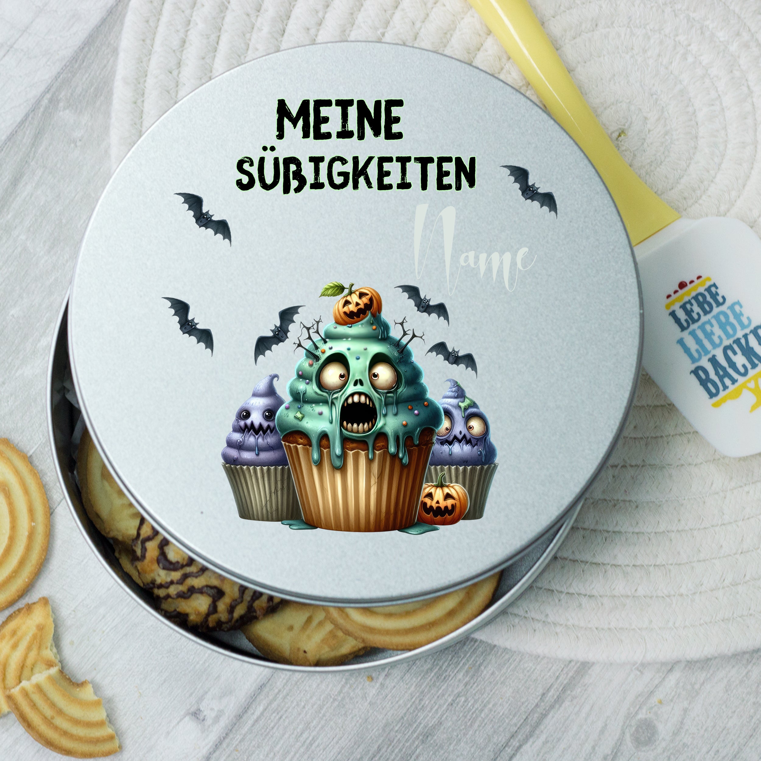 Graue Dose mit gruseligem Cupcake-Motiv und Halloween-Design.