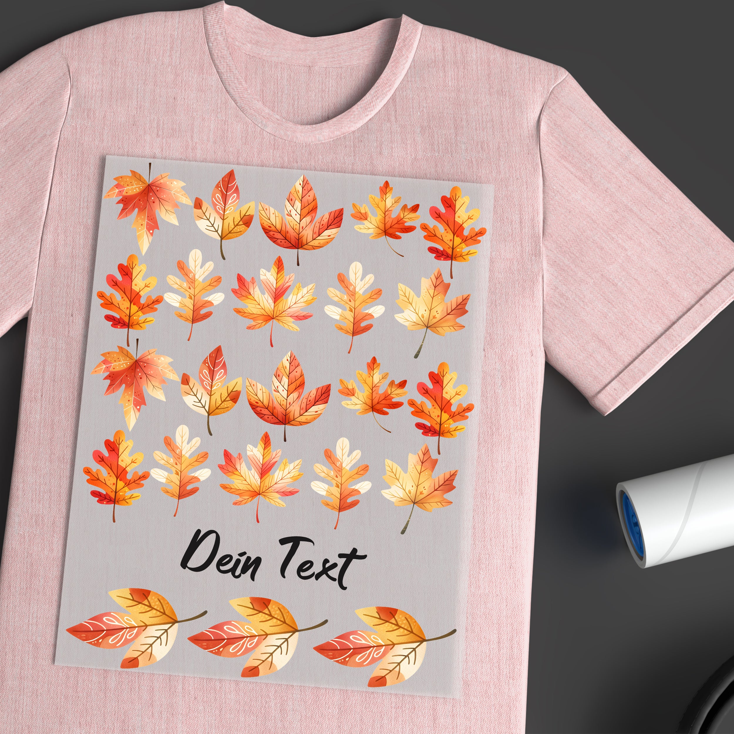 Rosa T-Shirt mit bunten Herbstblättern und Text.