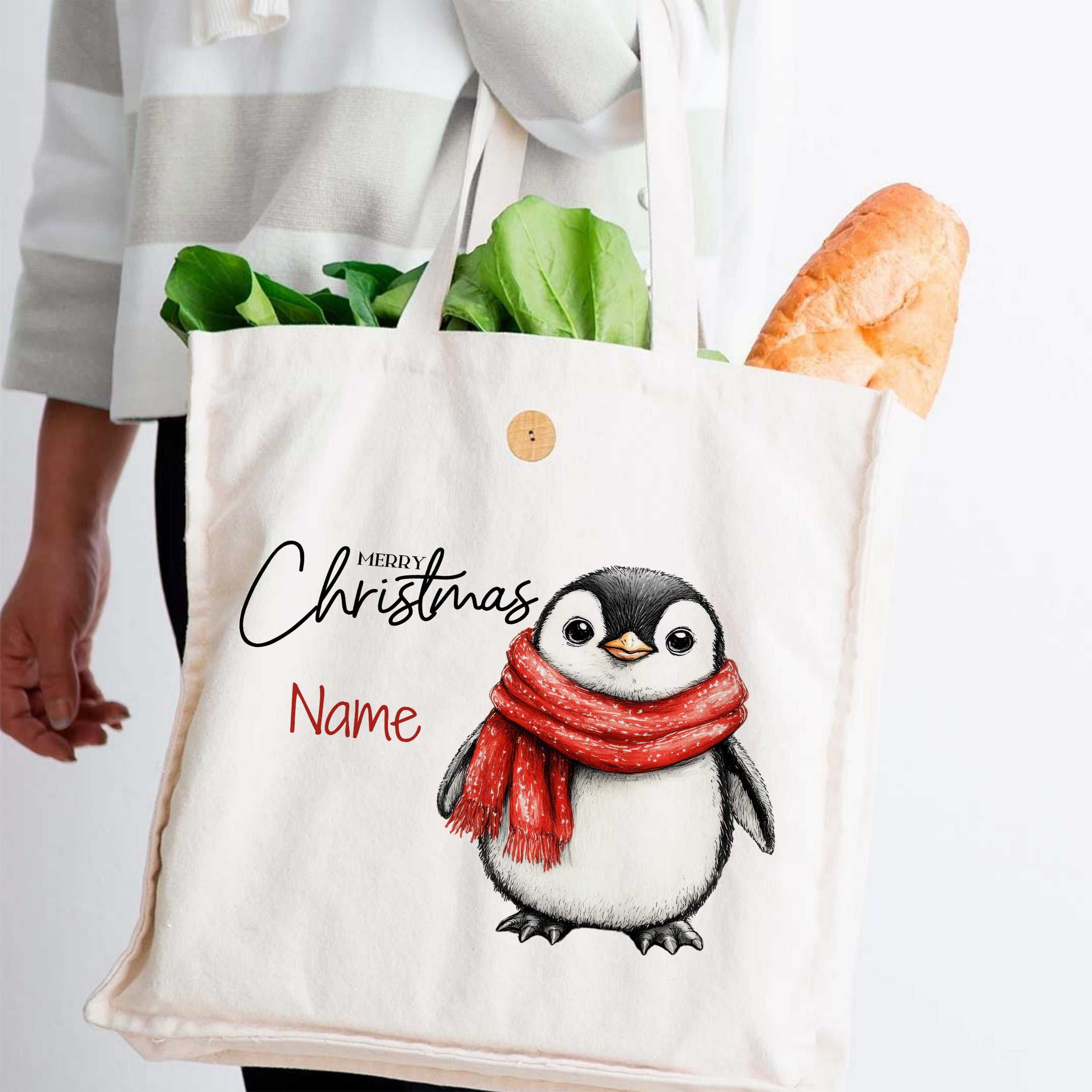 Weißer Stoffbeutel mit Weihnachts-Pinguin und rotem Schal.