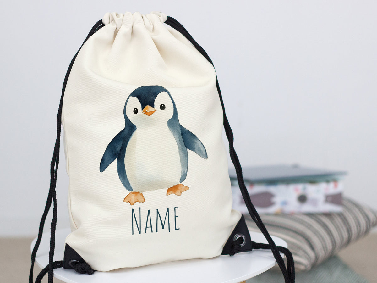 Beige Turnbeutel mit Pinguin-Motiv und Platz für Namen.
