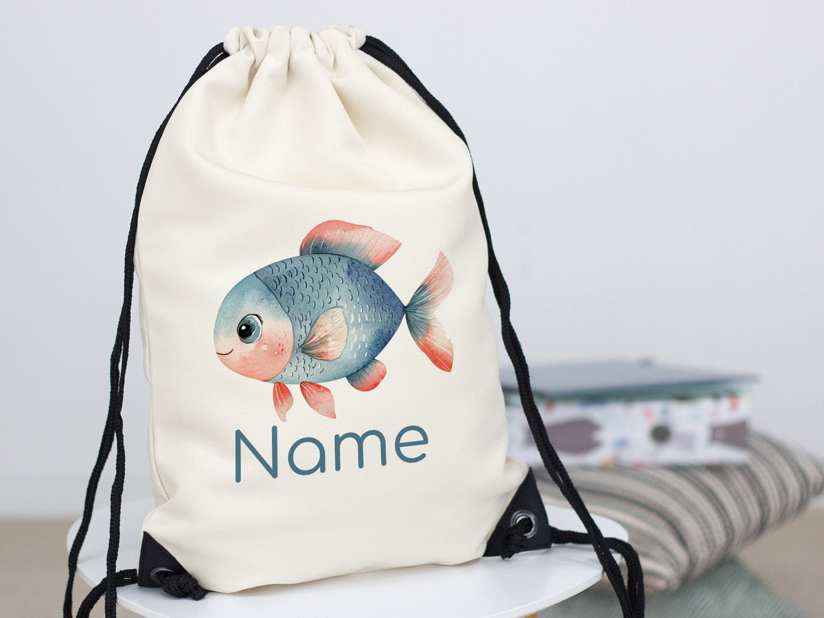 Beige Turnbeutel mit buntem Fisch und personalisiertem Namen.