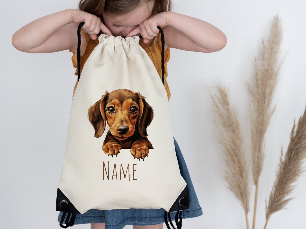 Beige Turnbeutel mit Dackel-Motiv und personalisierbarem Namen.