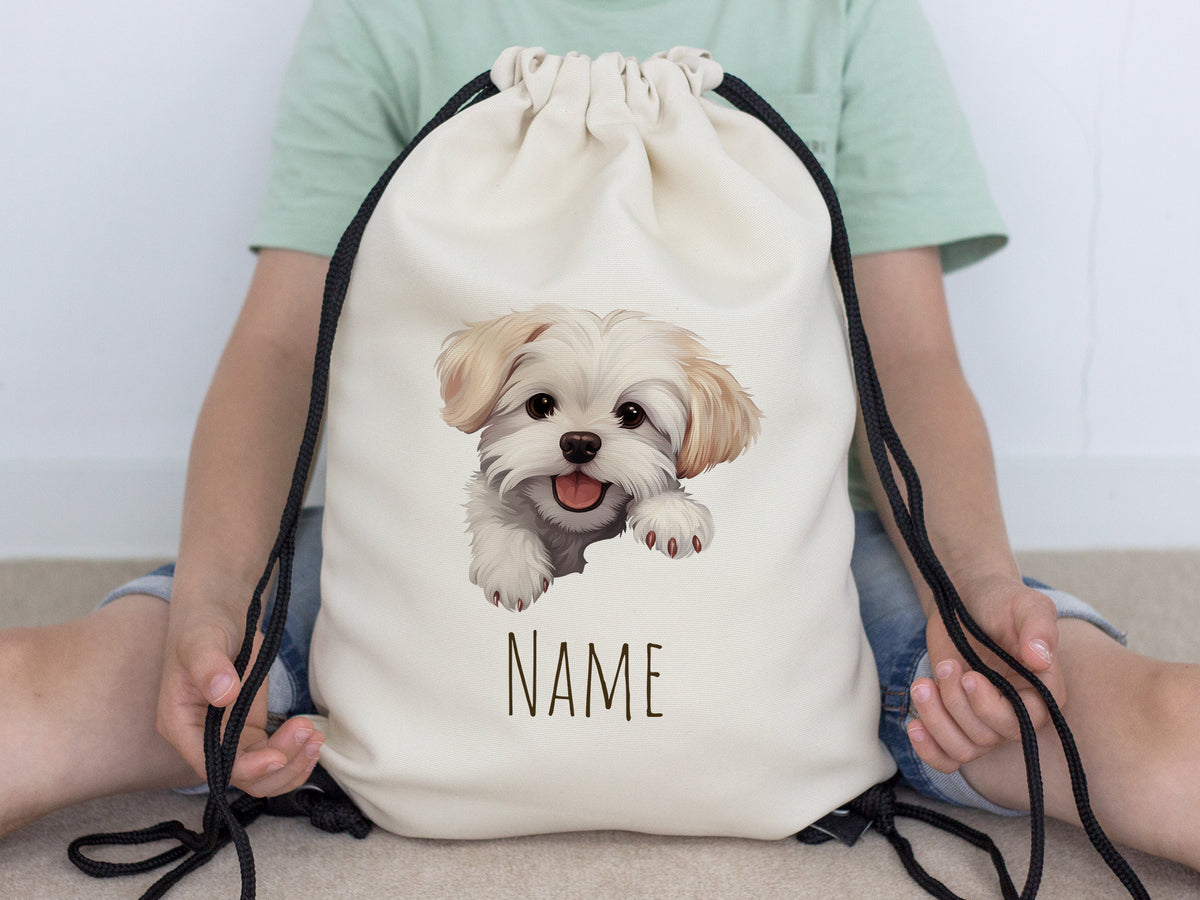 Beige Turnbeutel mit Hundemotiv und personalisierbarem Namen.