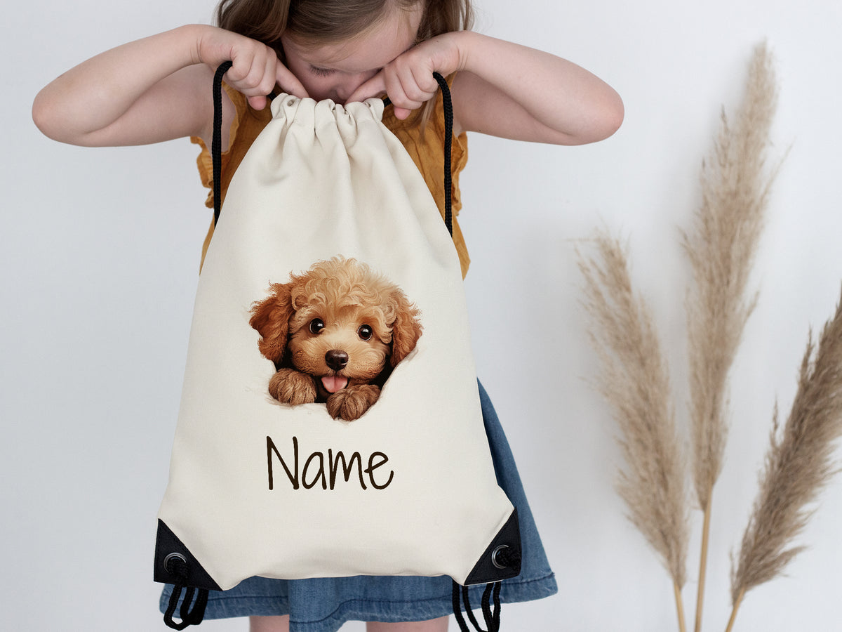 Beige Rucksack mit Hundemotiv und personalisiertem Namen.