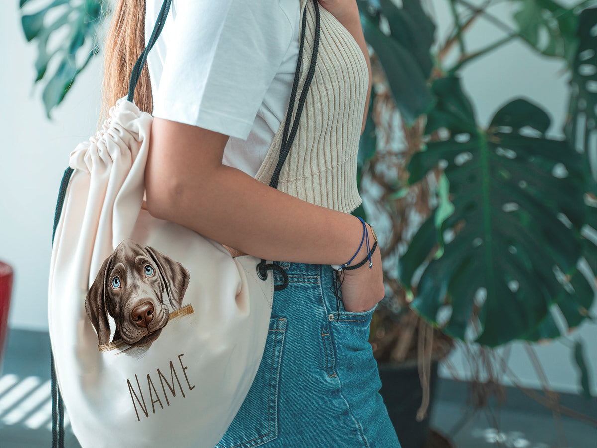 Beige Rucksack mit Hundemotiv und personalisiertem Namen.