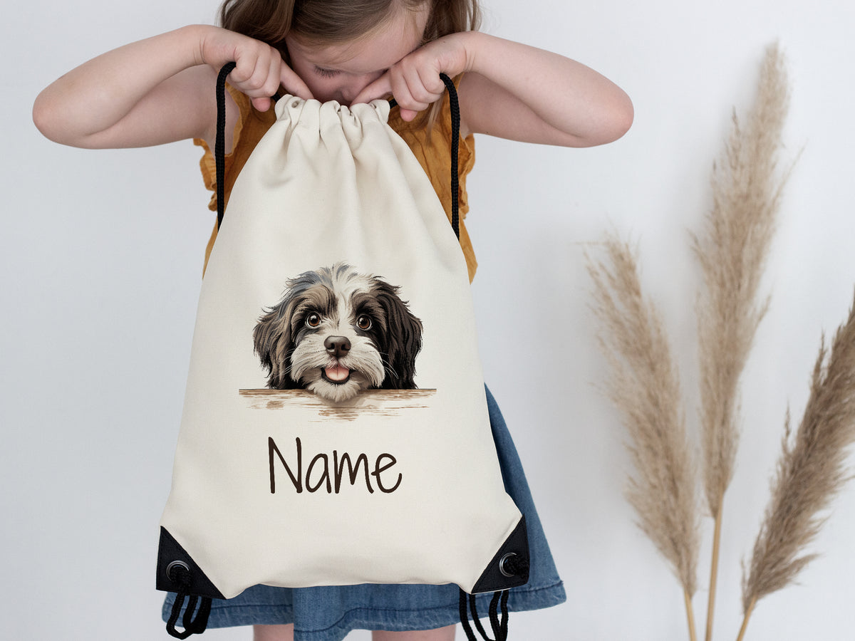 Beige Rucksack mit Hundemotiv und personalisierbarem Namen.