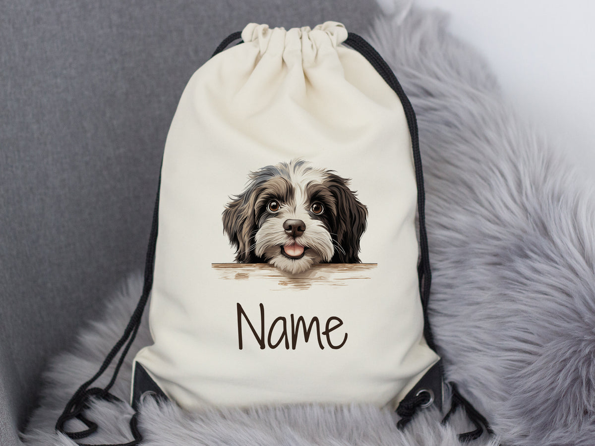 Beige Turnbeutel mit Hundemotiv und personalisiertem Namen.