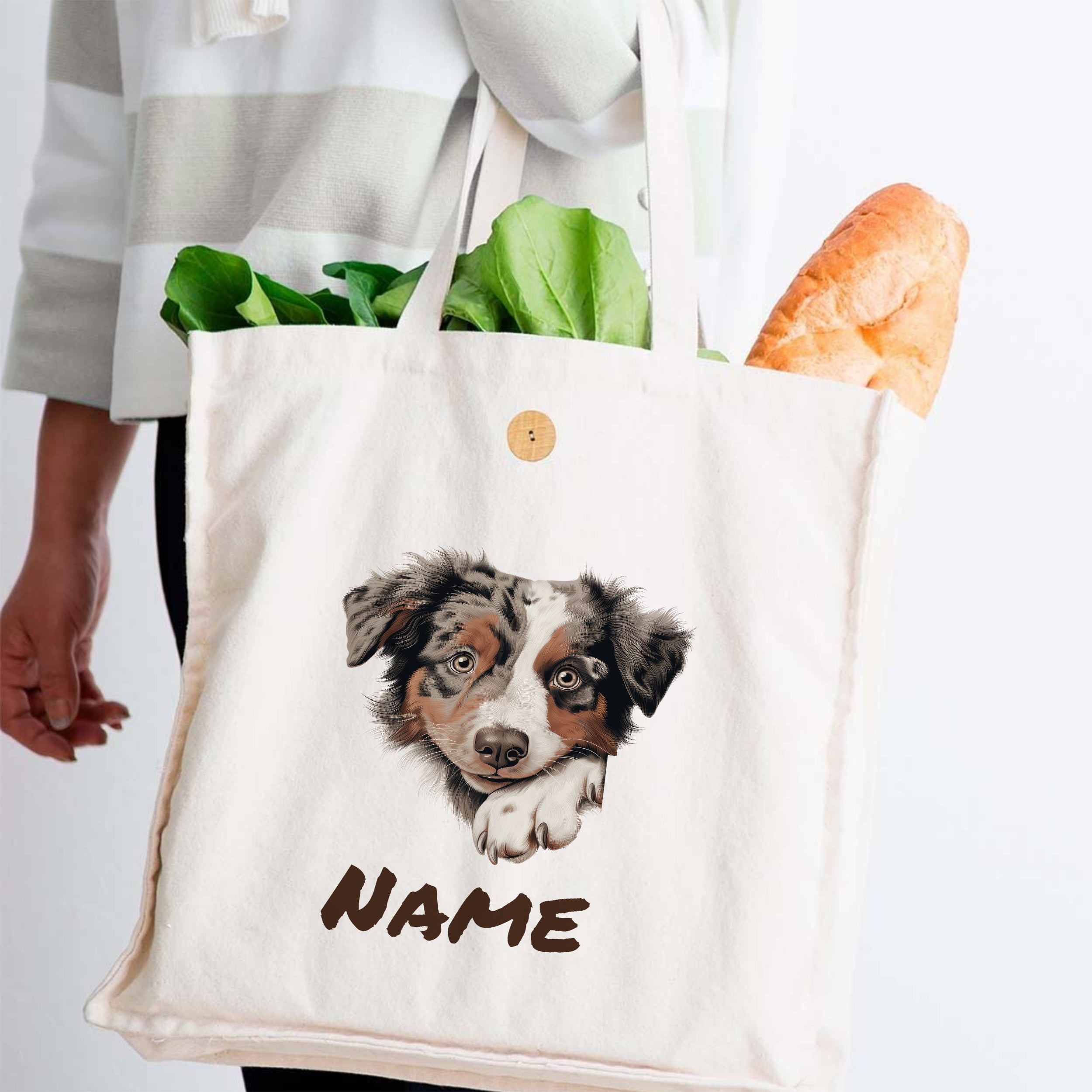 Beige Stofftasche mit Hundemotiv und personalisiertem Namen.