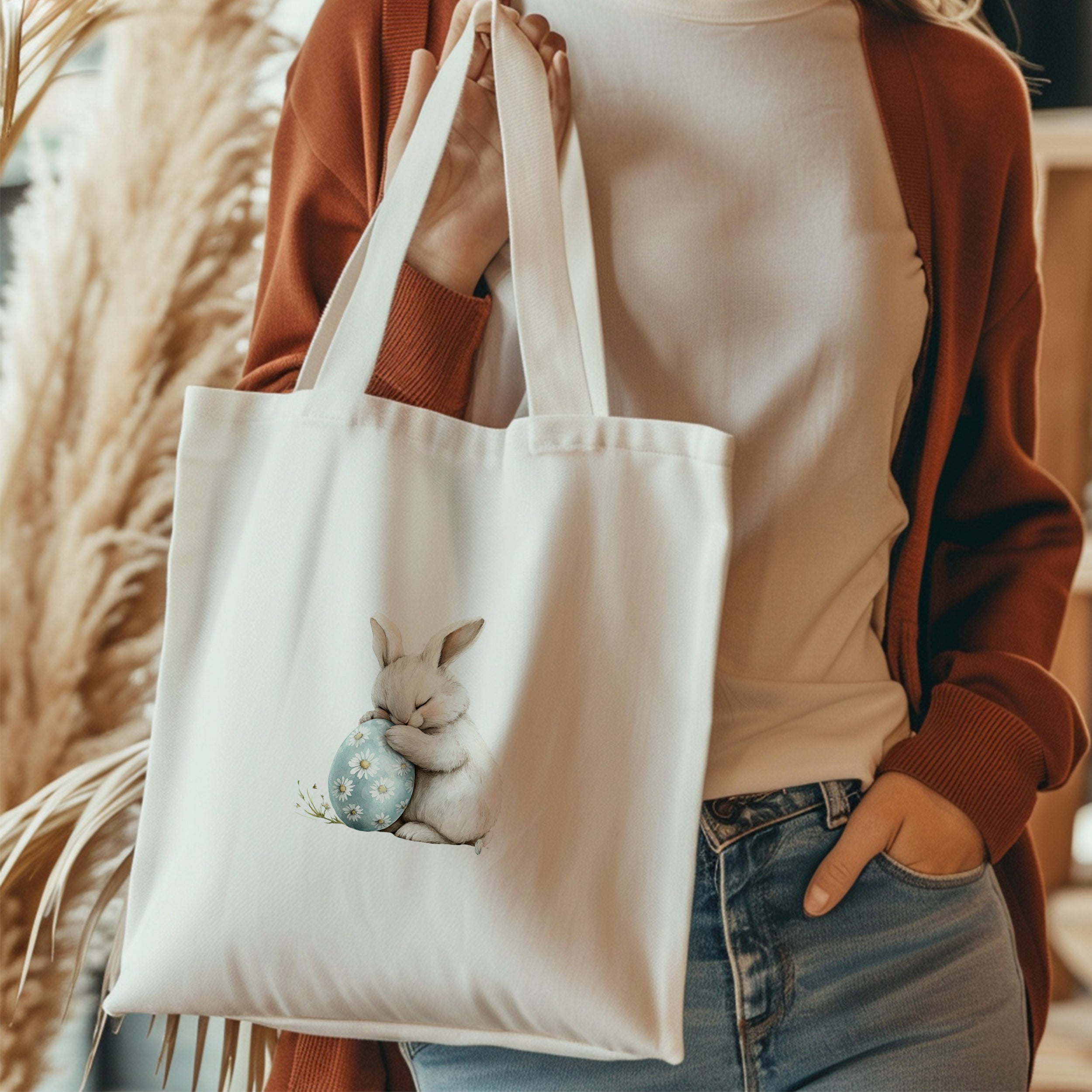 Weiße Stofftasche mit niedlichem Hasen und blauer Eierschale.