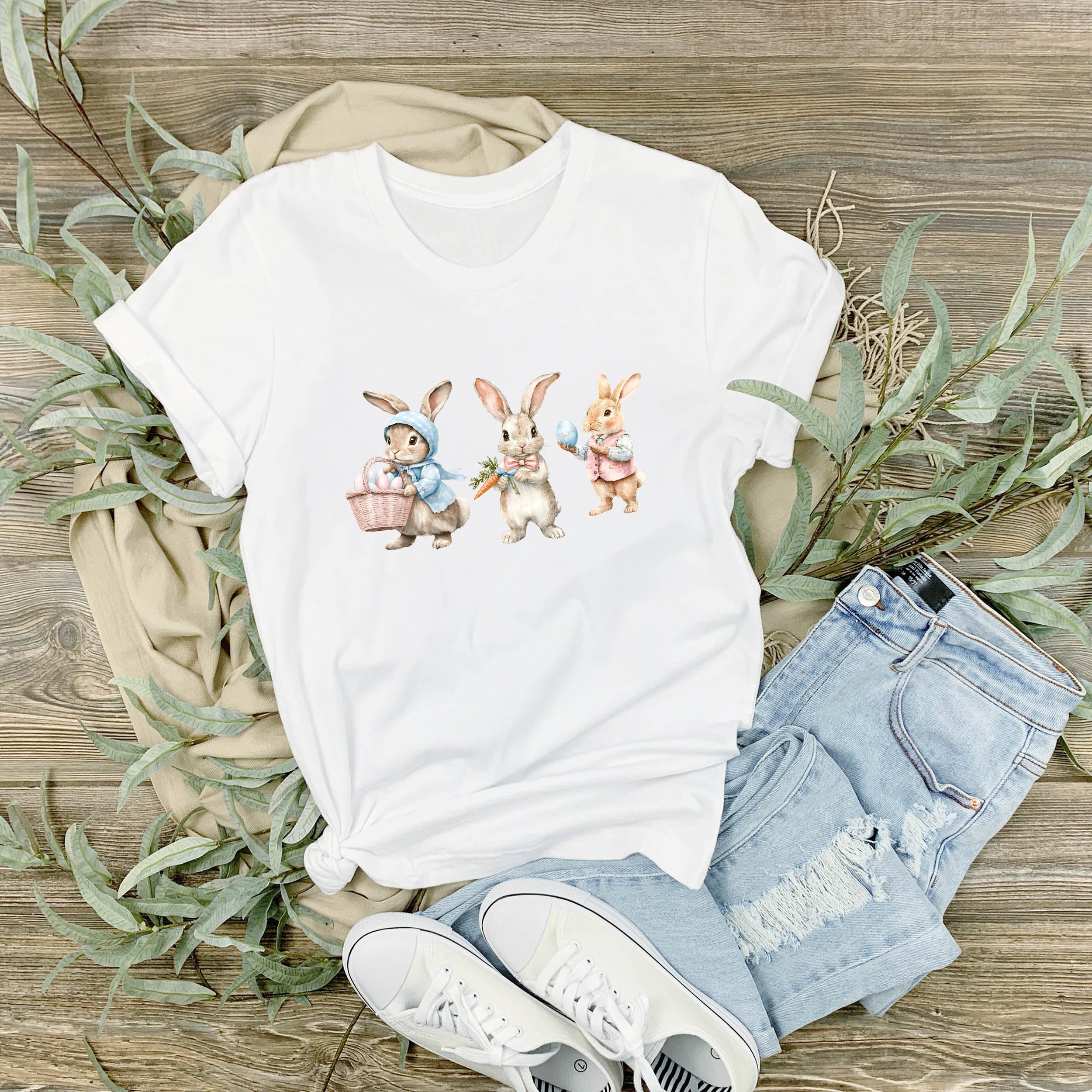 Weißes T-Shirt mit bunten Hasenmotiven und Jeansshorts.