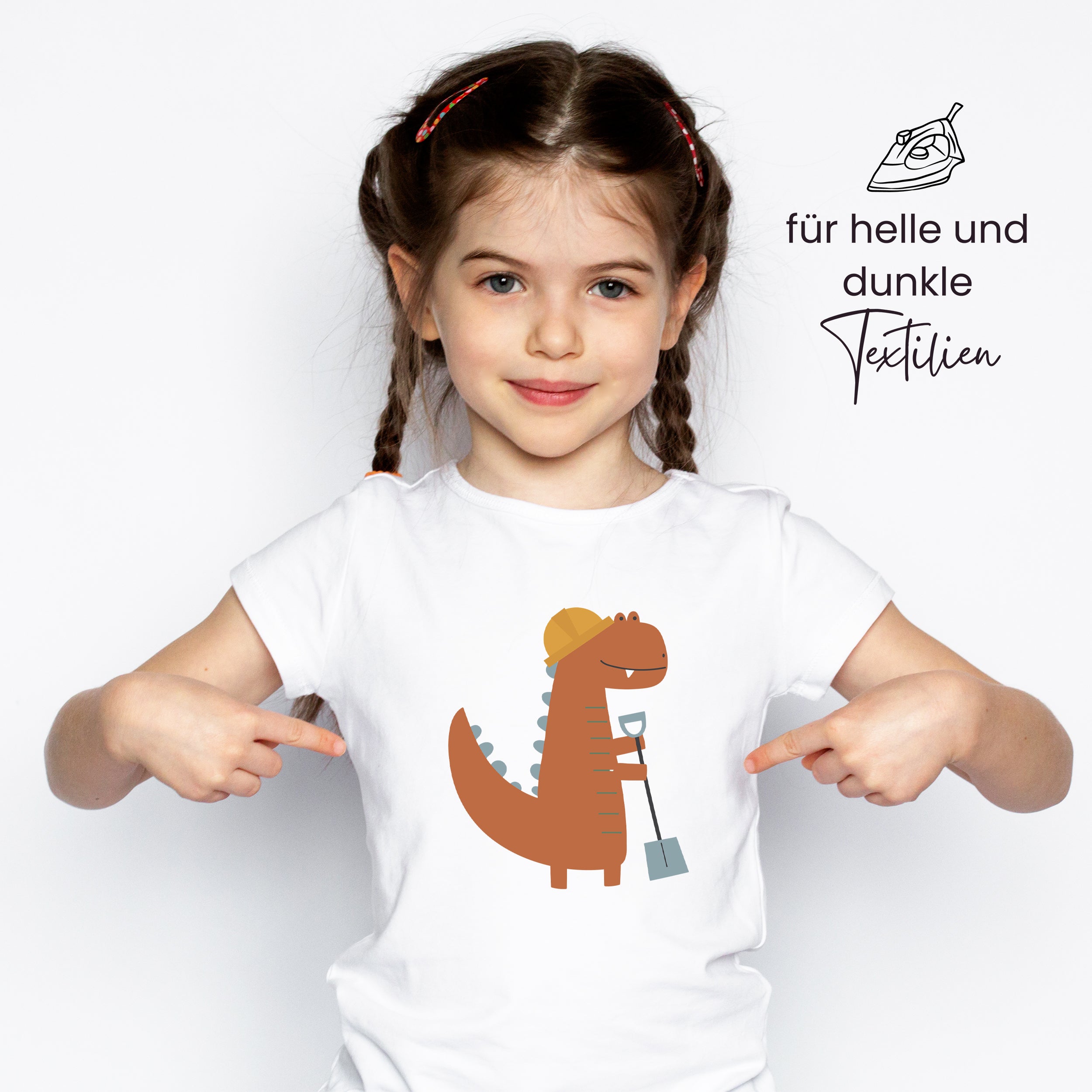 Weißes T-Shirt mit braunem Dinosaurier-Motiv und Schaufel.