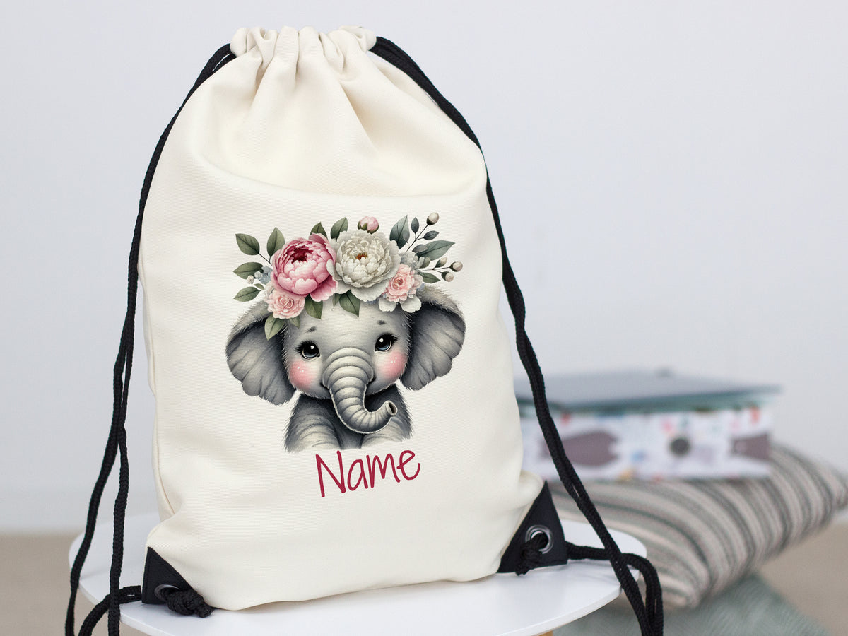 Beiger Rucksack mit Elefantenmotiv und Blumenkranz.