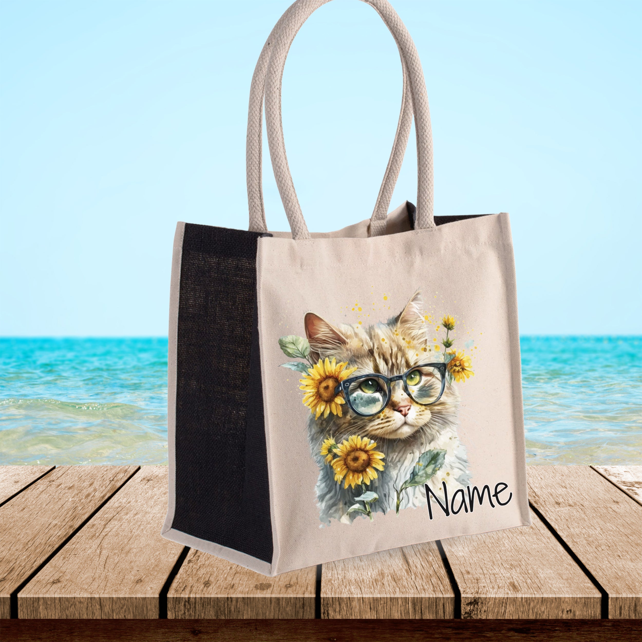 Beige Tasche mit Katzenmotiv und Sonnenblumen.