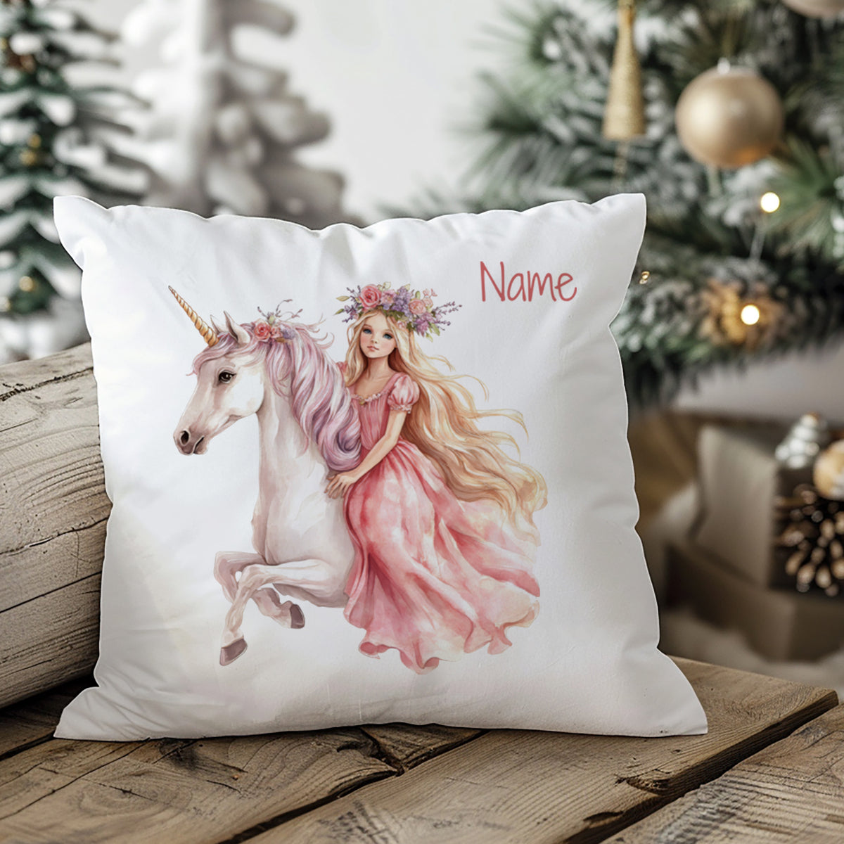 Kissen mit Einhorn und Mädchen in rosa Kleid.