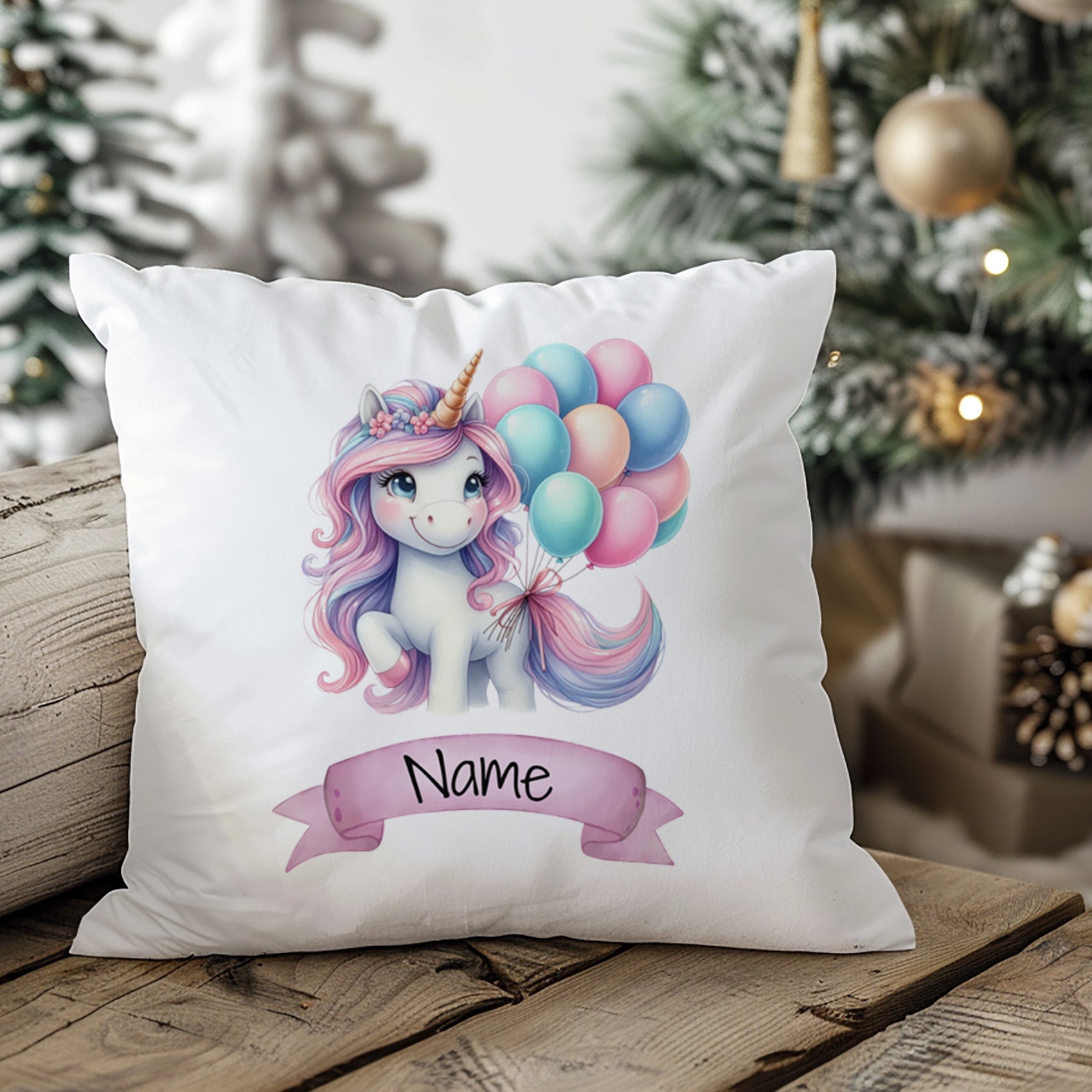Kissen mit Einhorn, bunten Ballons und personalisierbarem Namen.