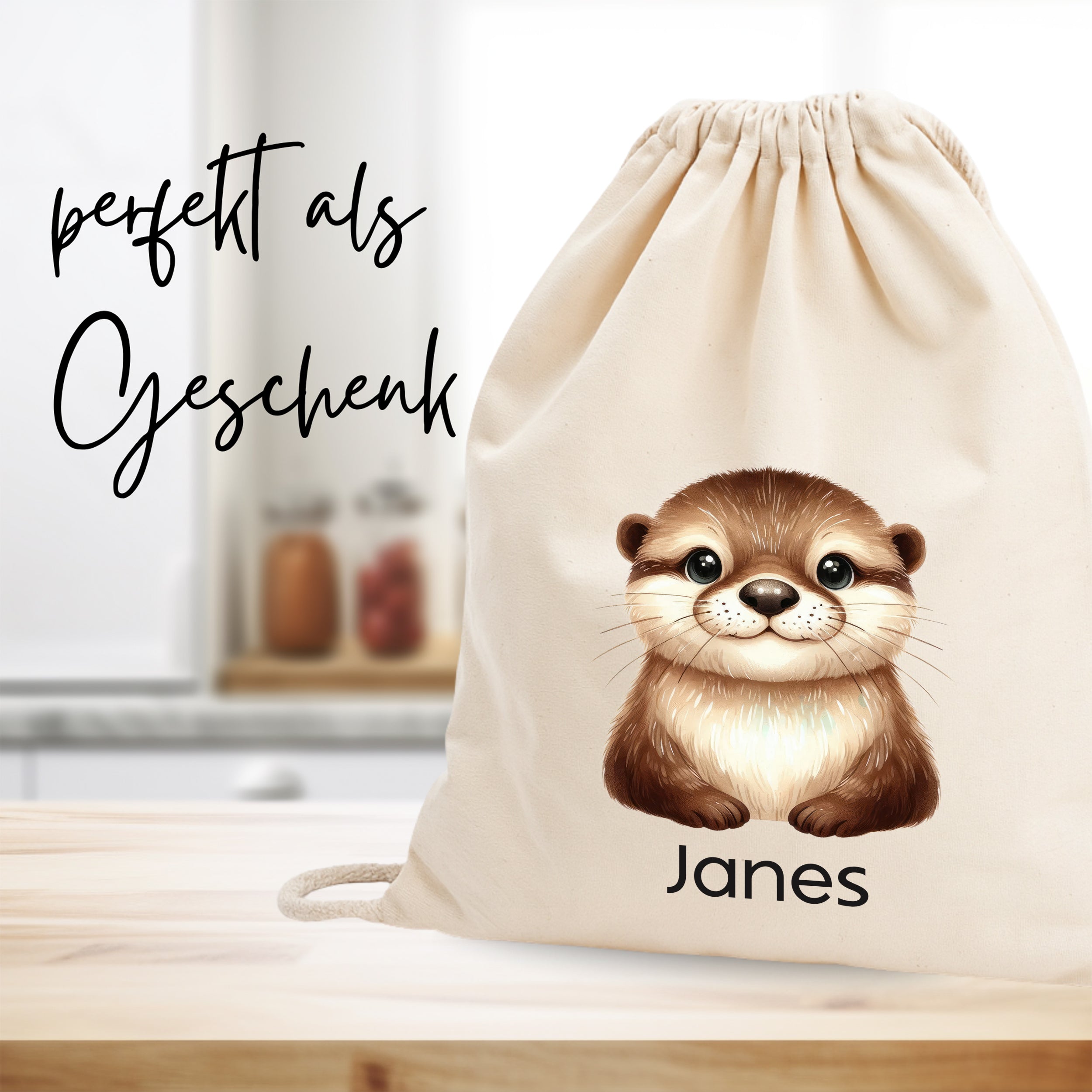 Beige Stoffbeutel mit Otter-Motiv und dem Namen Janes.