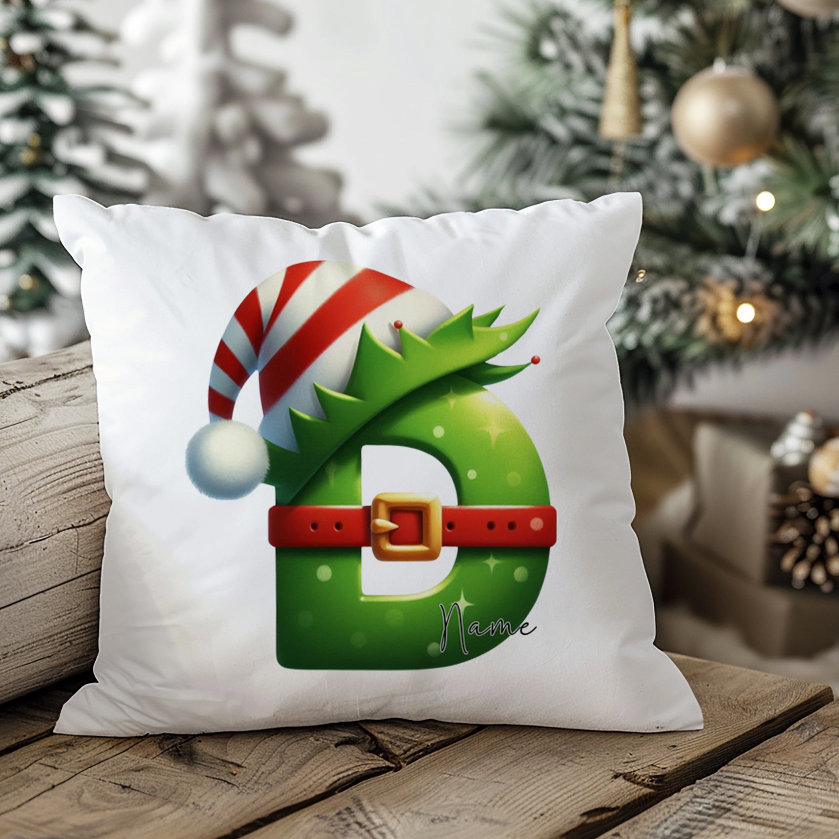Weihnachtliches Kissen mit grünem Buchstaben D und Hut.