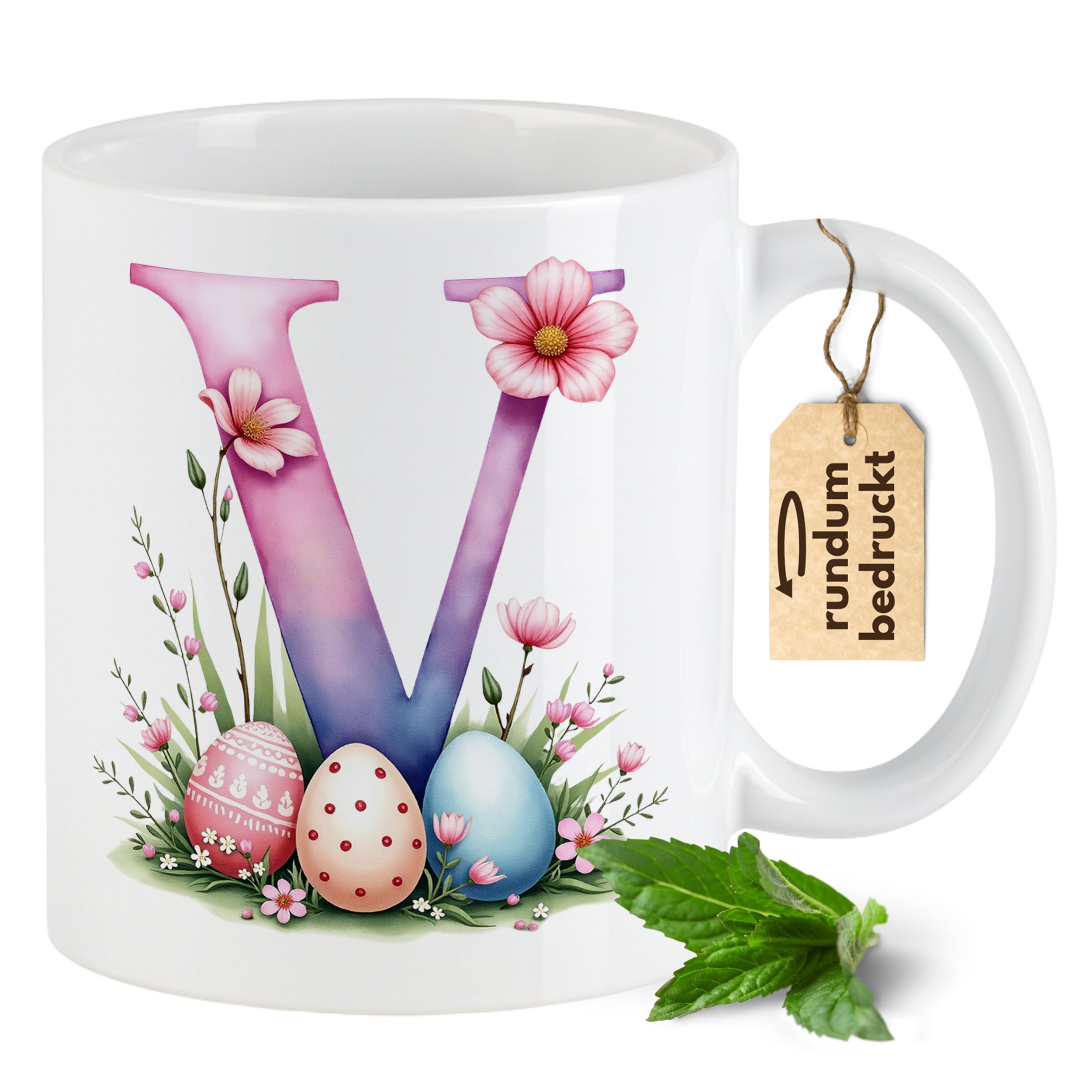 Tasse mit buntem V, Ostereiern und Blumenmotiv.