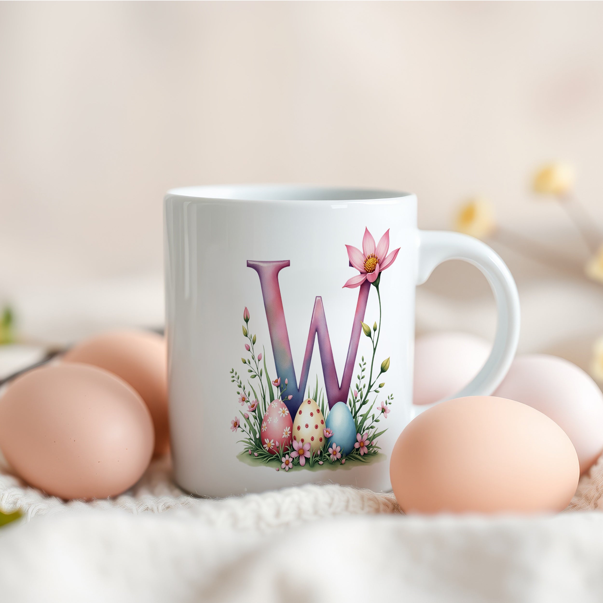Weiße Tasse mit buntem "W" und Ostereiern.