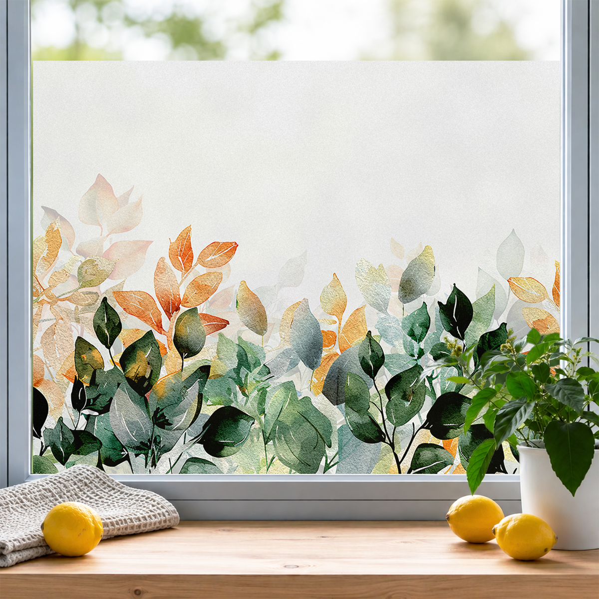 Frosted Fensterfolie mit bunten Blättern in Grün und Orange.
