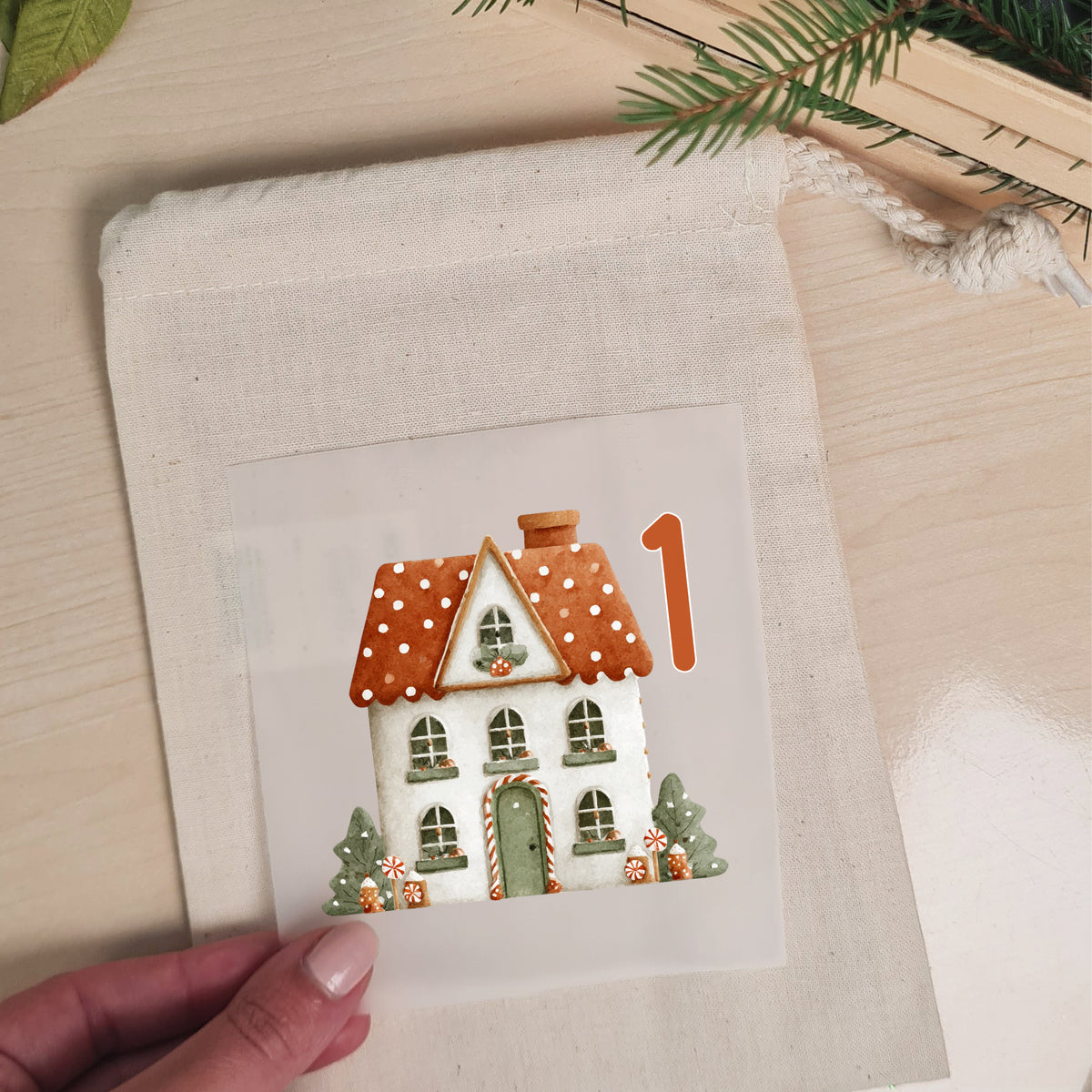 Winterhaus mit Zahl 1 als Bügelbild auf einem naturfarbenen Stoffbeutel