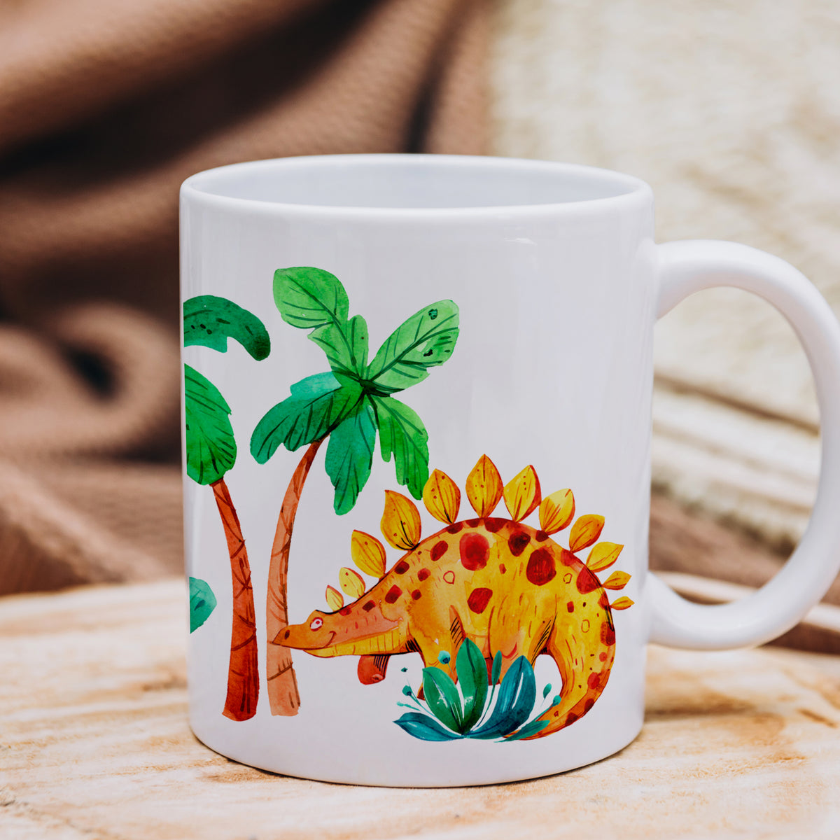 Tasse mit buntem Dinosaurier und Palmenmotiven.