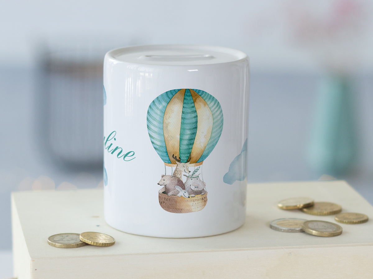 Sparschwein mit Luftballon-Motiv in Pastellfarben.