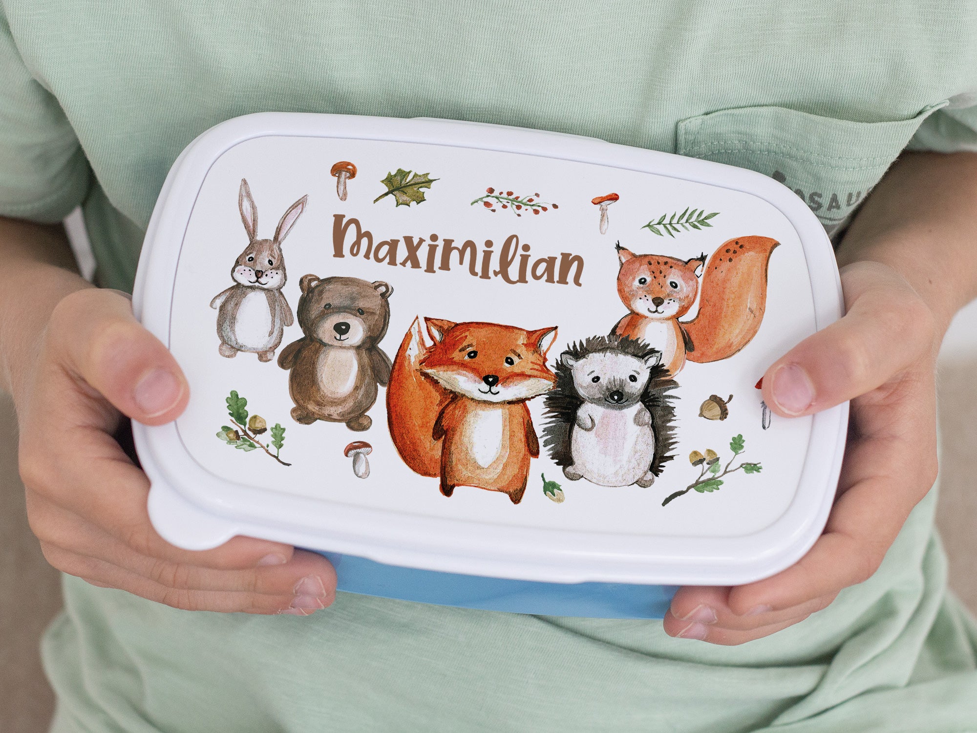 Bunte Brotdose mit Tieren und dem Namen Maximilian.