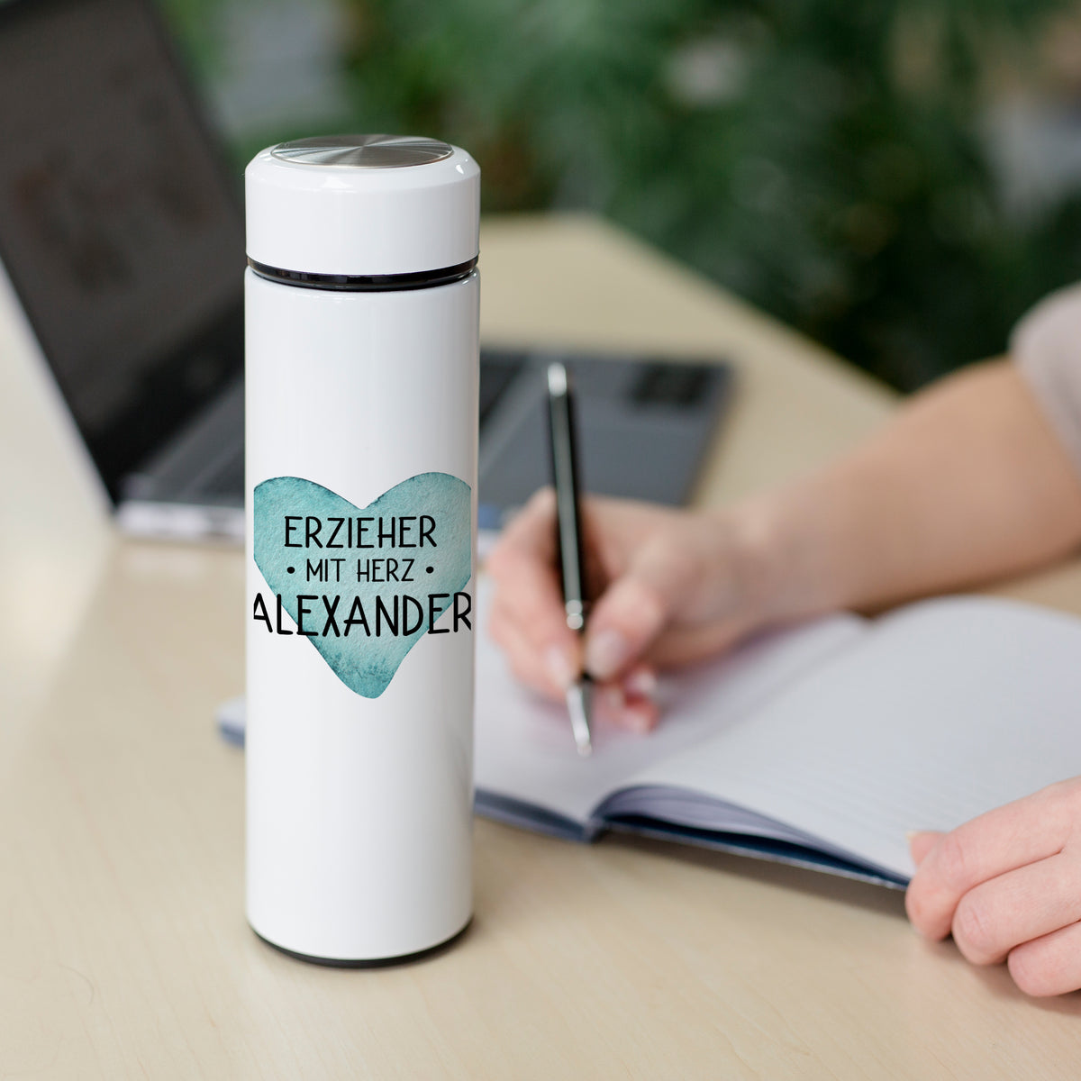 Weiße Trinkflasche mit Herzmotiv und personalisiertem Namen.