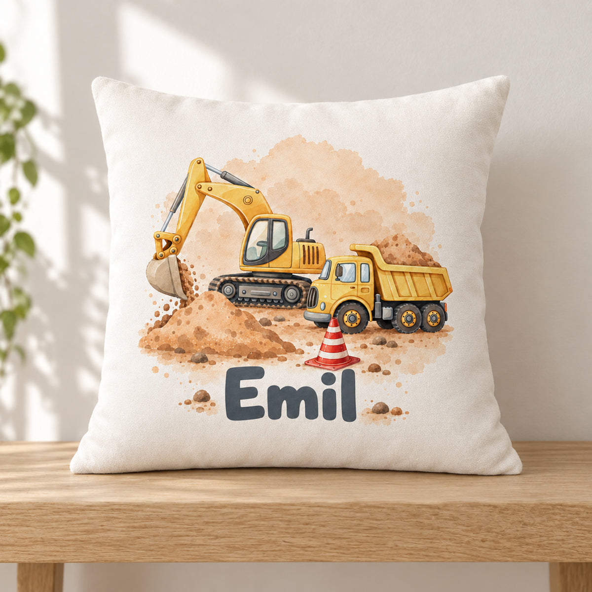 Kissenbezug mit Bagger und Kipplaster und Beispielname Emil in einer schlichten Leseecke.