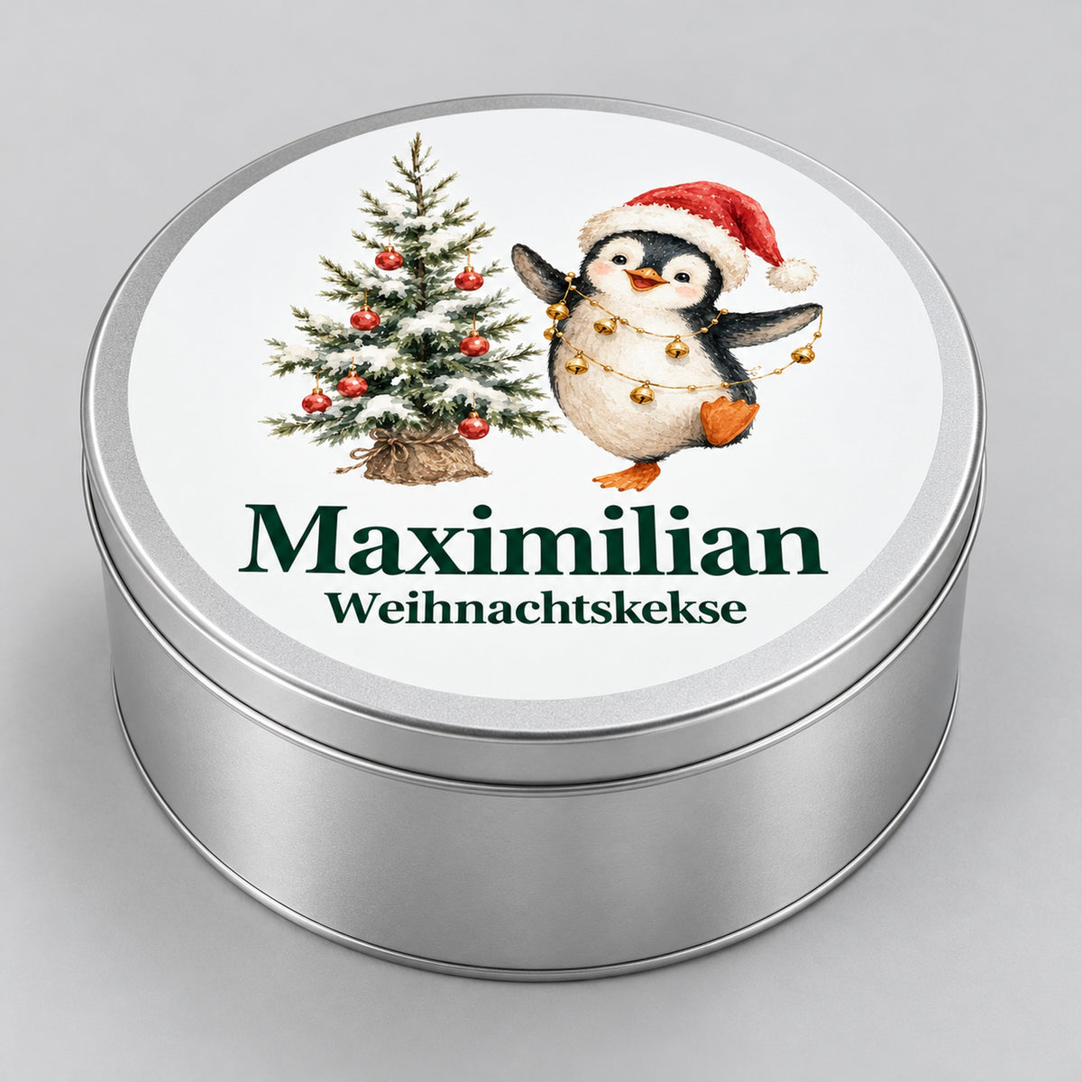 Seitenansicht einer runden Keksdose mit Pinguin mit Glöckchenkette und Wunschname.
