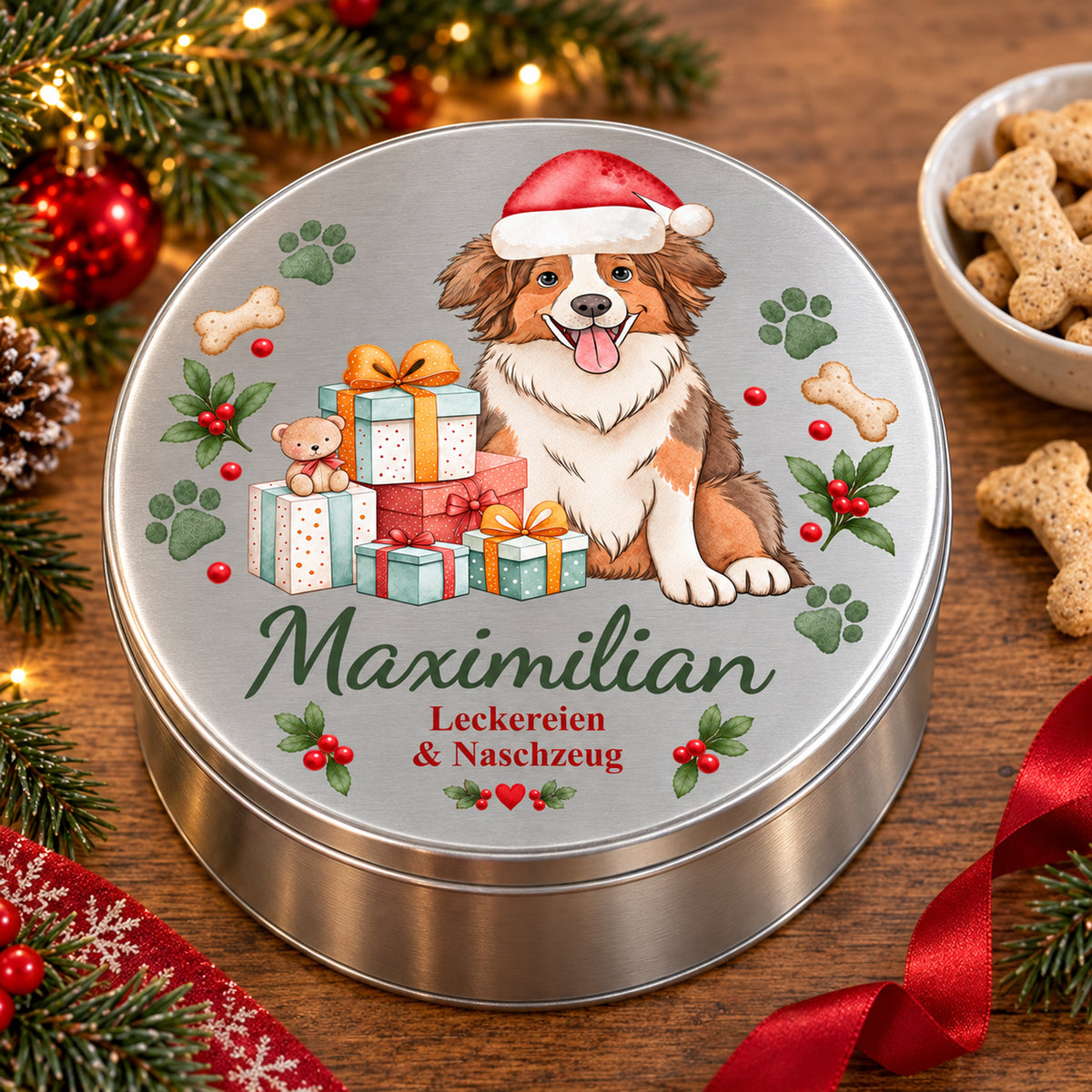 Geschlossene Australian Shepherd-Leckerlidose als Weihnachtsgeschenk neben Hundeleckerlis und weihnachtlicher Dekoration