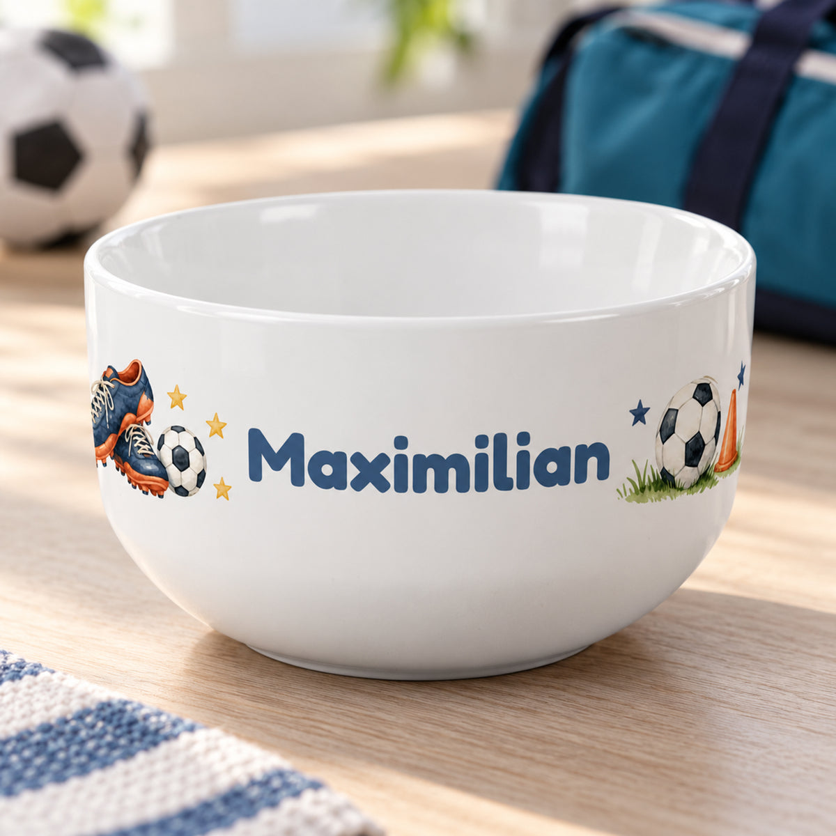 Müslischale mit Fußballschuhen und Ball und Wunschname schräg von vorne mit sichtbarem Innenraum