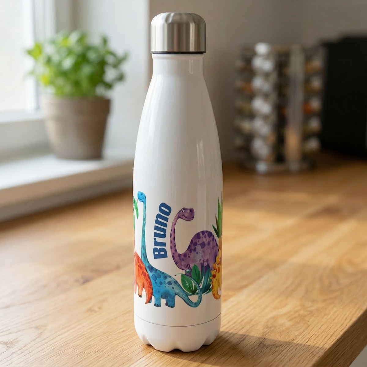 Weiße Edelstahl-Trinkflasche mit bunten Dinosaurier-Motiven.