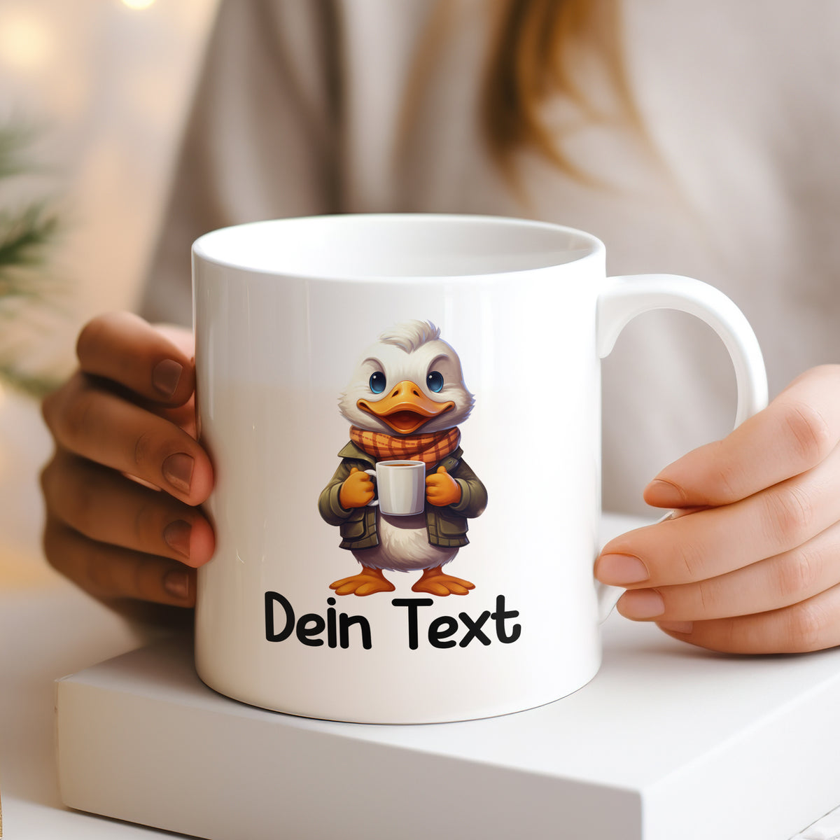 Weißer Becher mit Entenmotiv und personalisiertem Text.