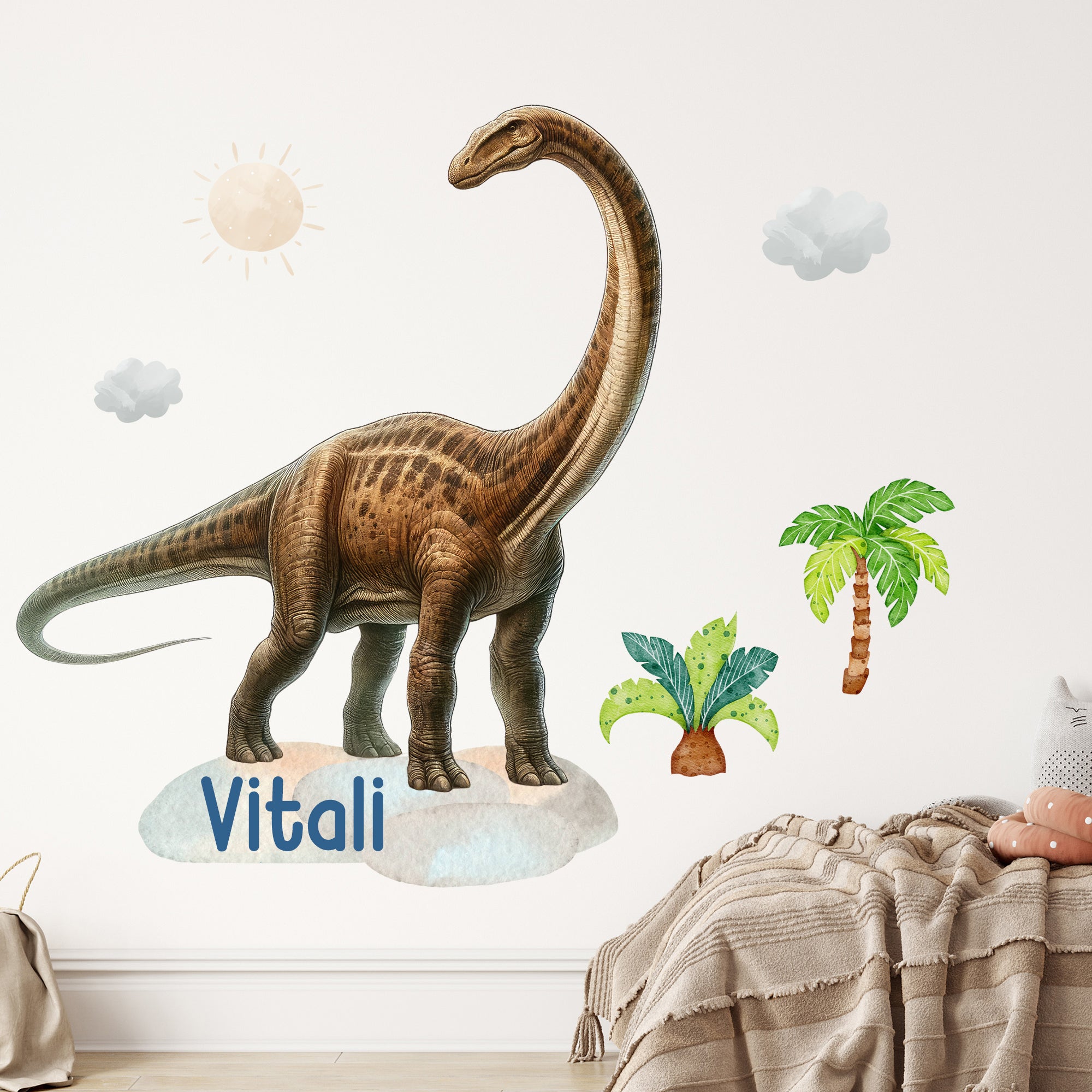 Wandtattoo mit Langhals-Dinosaurier und Wunschname über Kinderbett