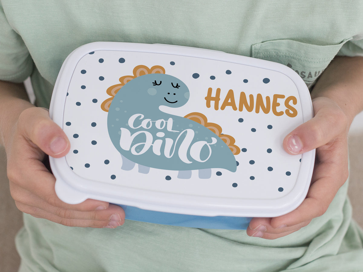 Bunte Lunchbox mit Dinosaurier-Motiv und Namen Hannes.