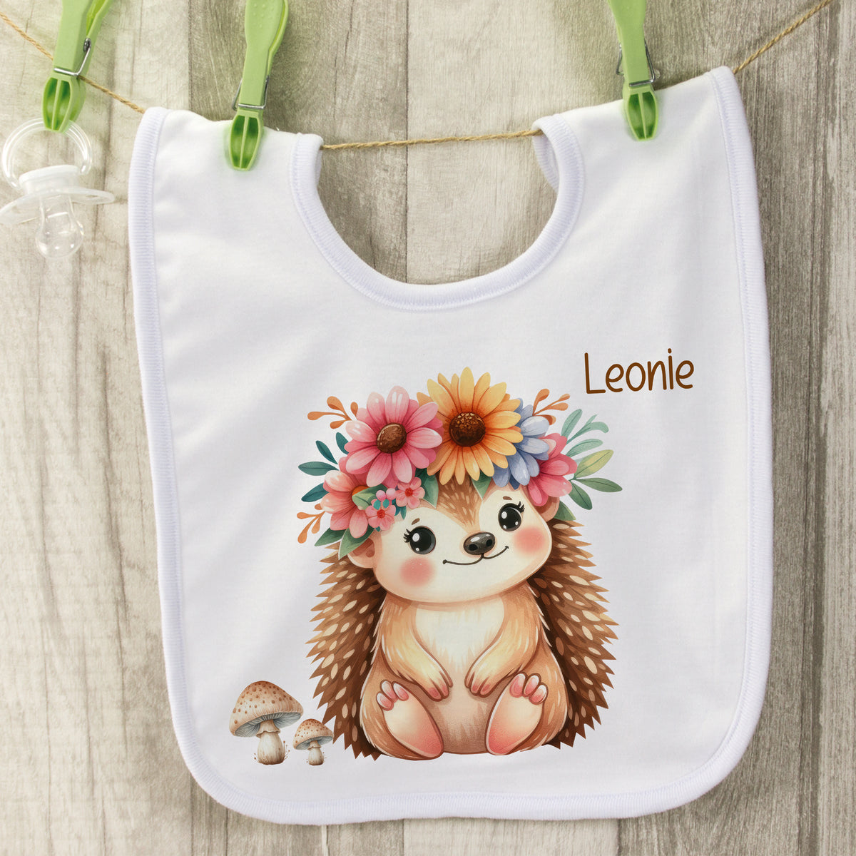 Lätzchen mit niedlichem Igel und Blumenkranz, personalisiert.