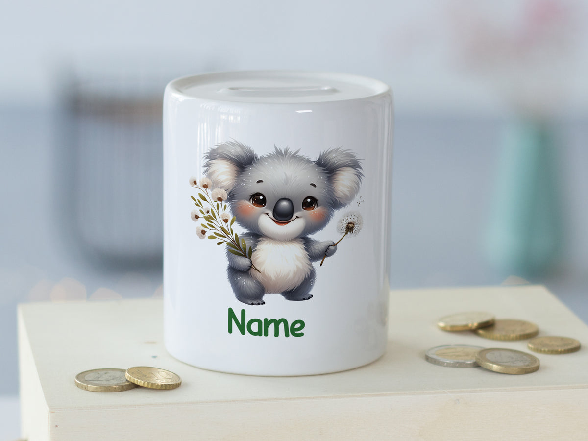 Kleine Spardose mit niedlichem Koala-Motiv und grüner Schrift.